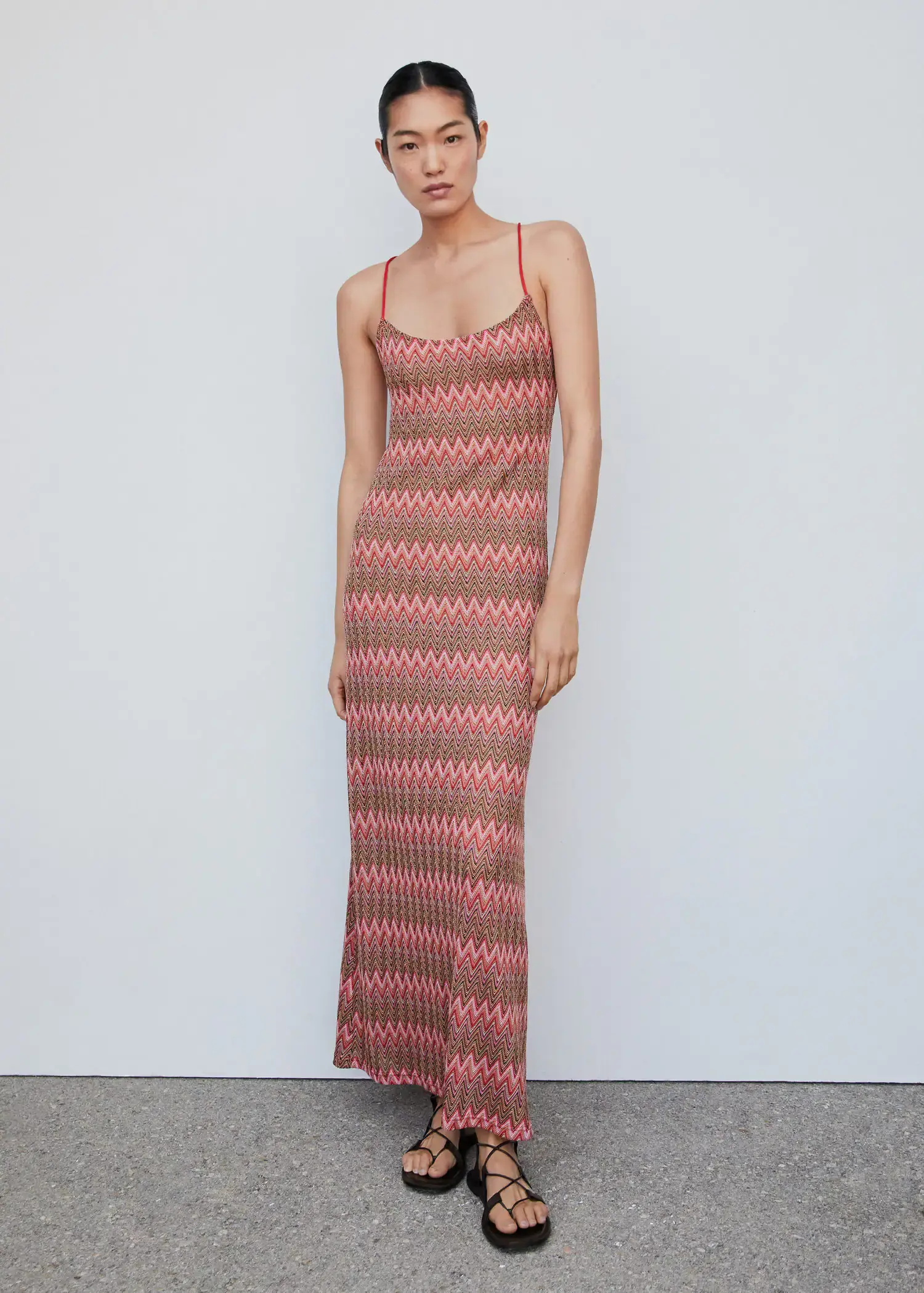 Mango Geometric pattern dress. a woman wearing a long dress standing in front of a white wall. 