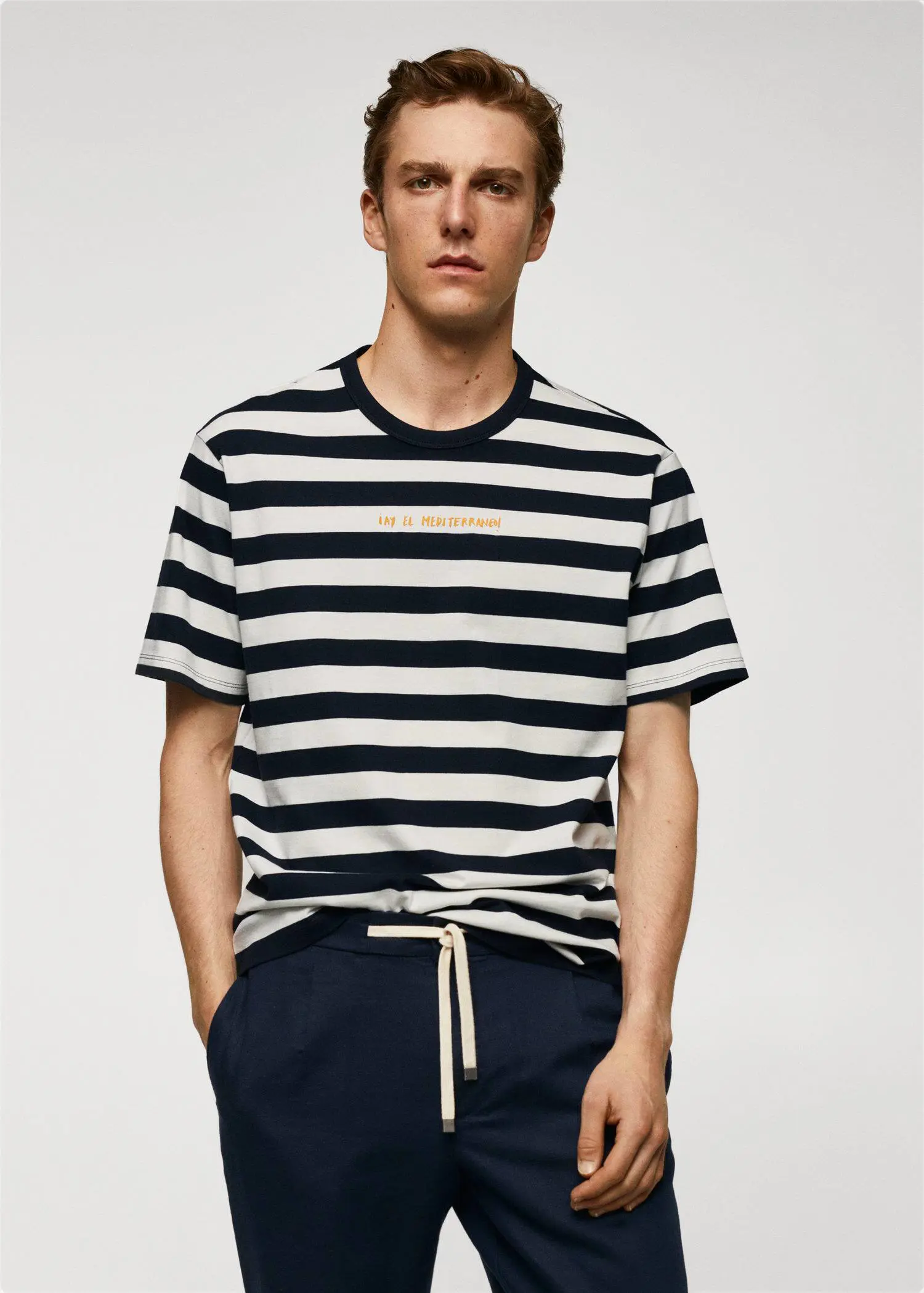 Mango Adriana Eskenazi x Mango t-shirt. a young man wearing a striped t-shirt. 