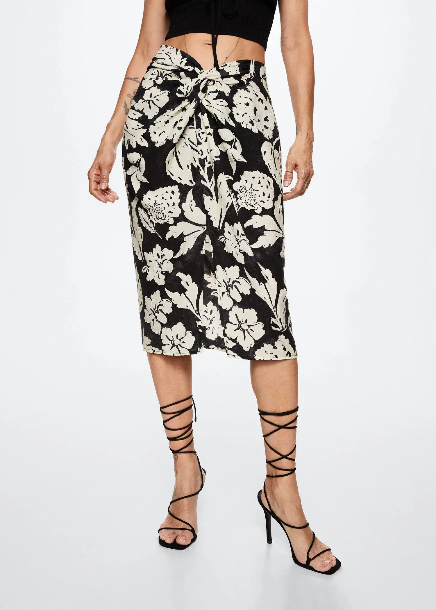 Mango Slit floral skirt. a woman wearing a black and white floral skirt. 