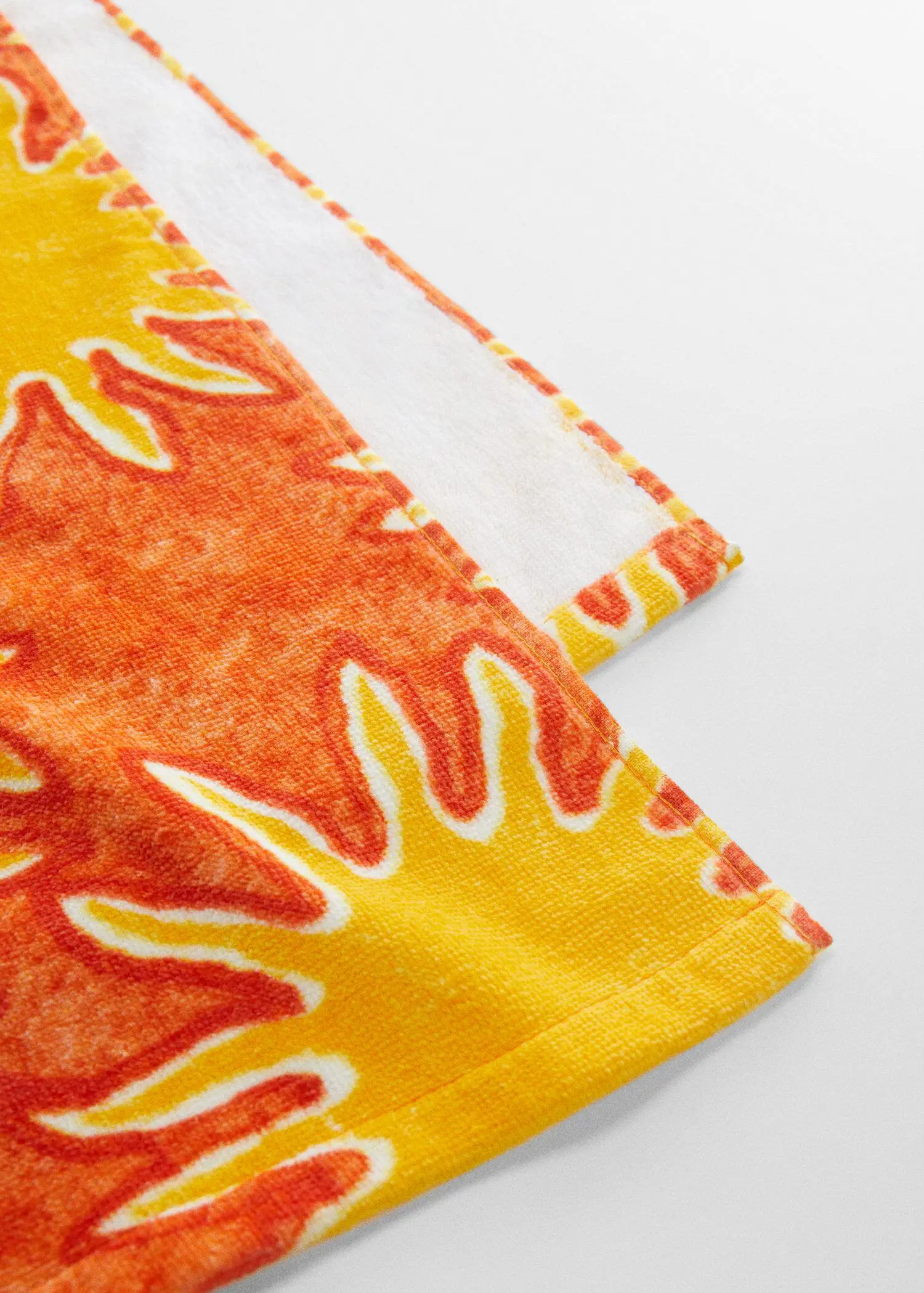 Mango 100% cotton printed towel. a close-up view of a yellow and orange towel. 