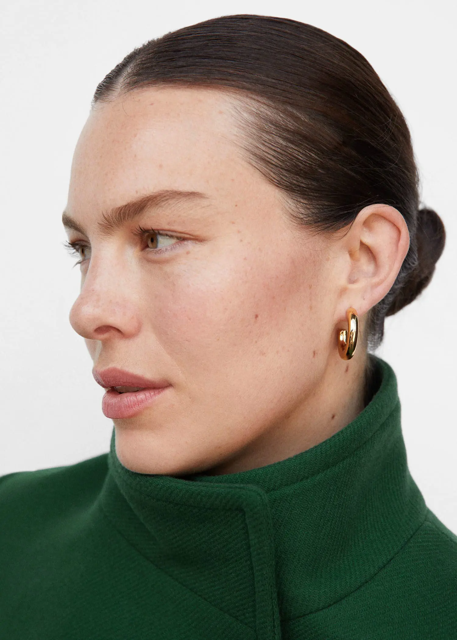 Mango Belted Manteco wool coat. a close up of a person wearing earrings 