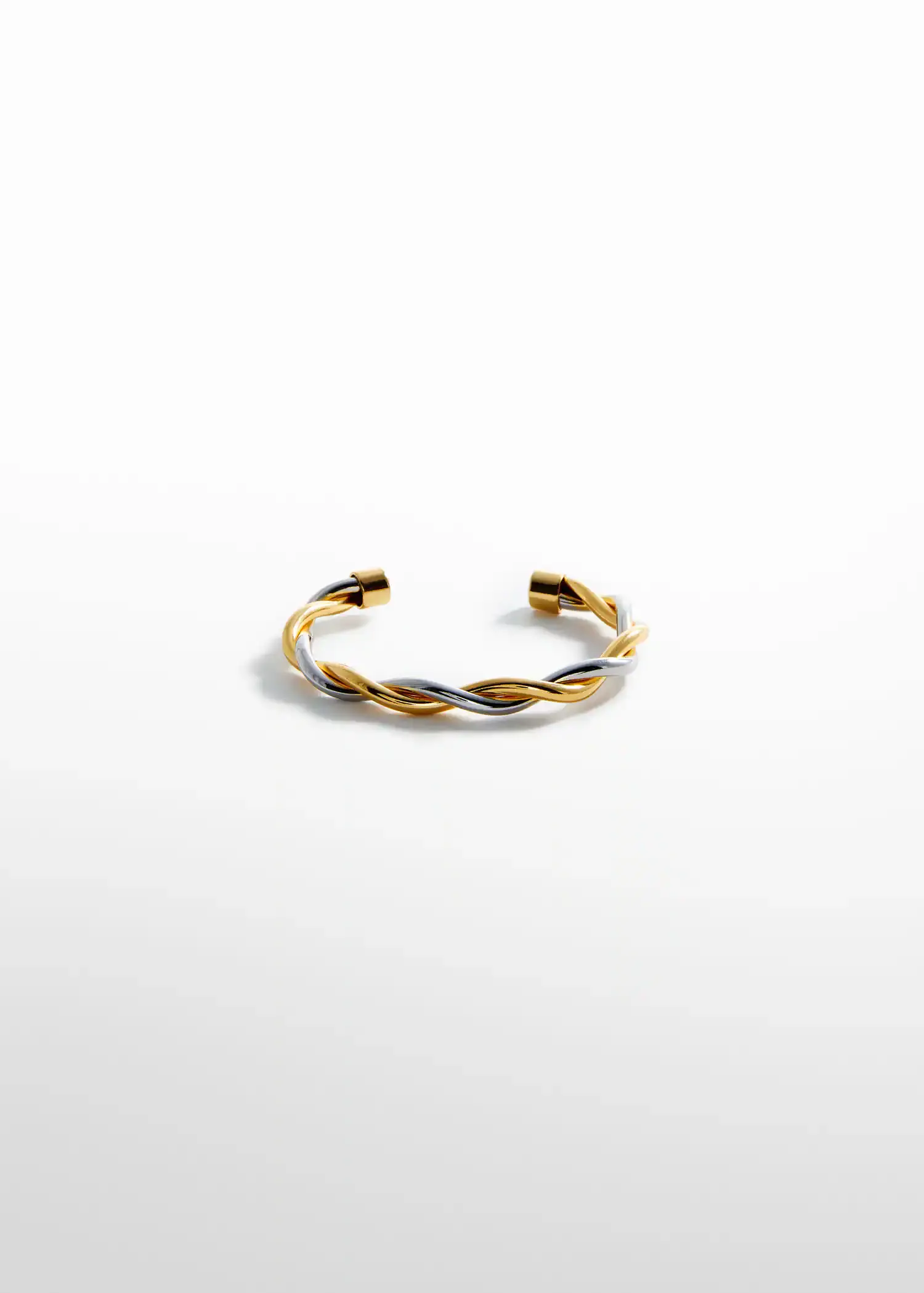 Mango Rigid interlocking bracelet. a gold and silver bracelet on top of a white surface. 