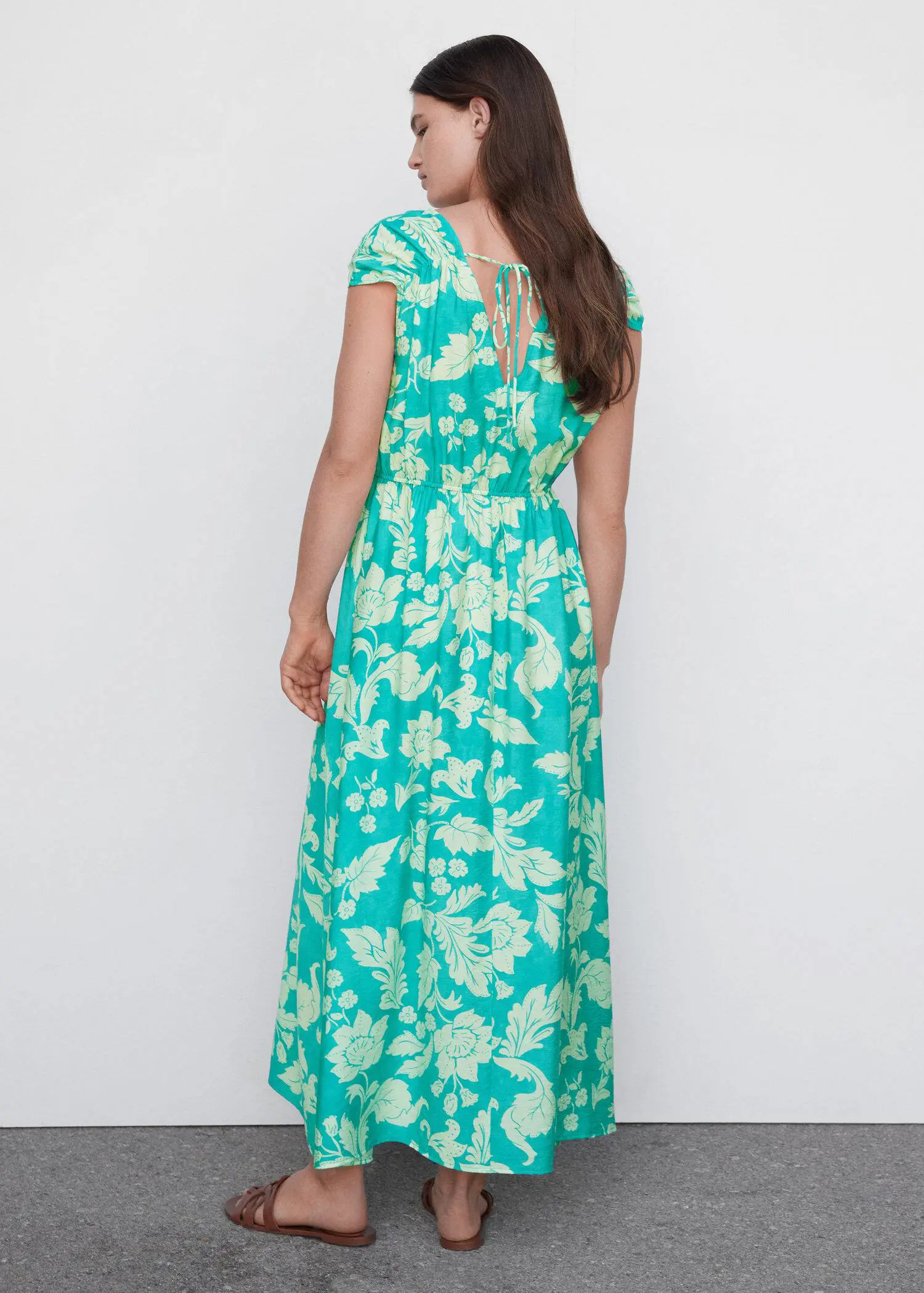 Mango Floral wrap neckline dress. a woman wearing a long green floral dress. 