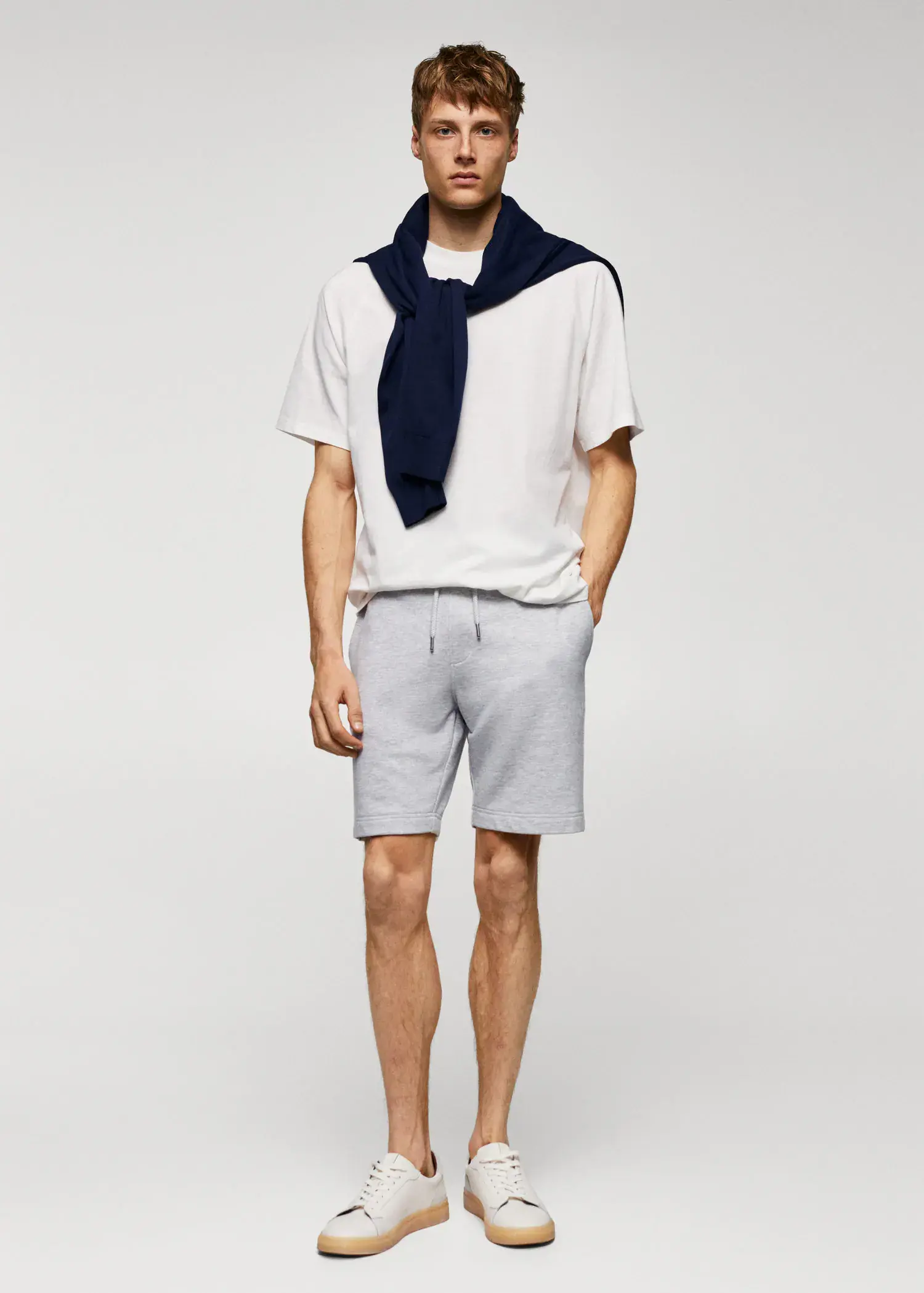 Mango Jogger cotton Bermuda shorts. a young man wearing shorts and a white t-shirt. 