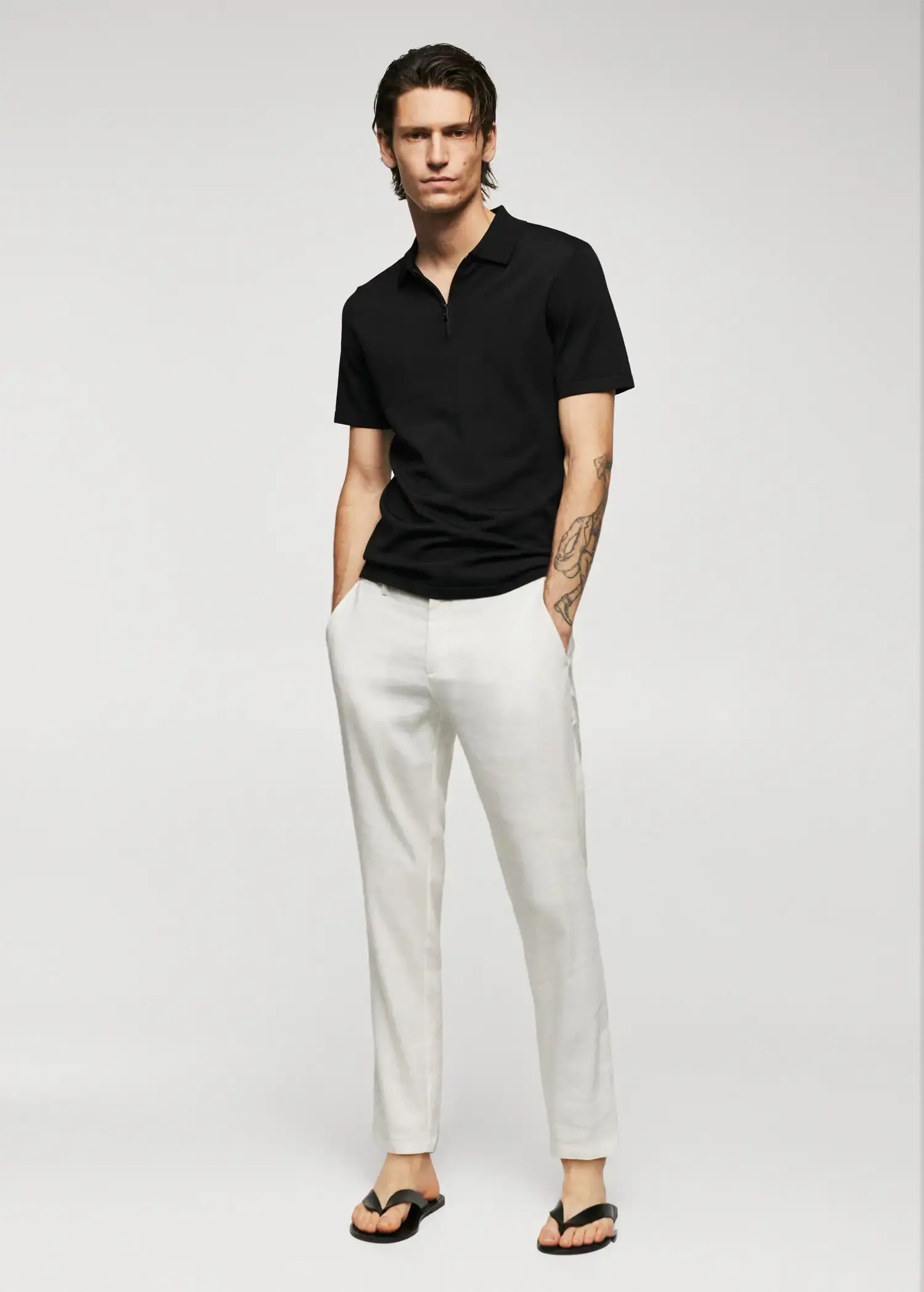 Mango Fine-knit polo shirt with zipper. a man wearing a black shirt and white pants. 
