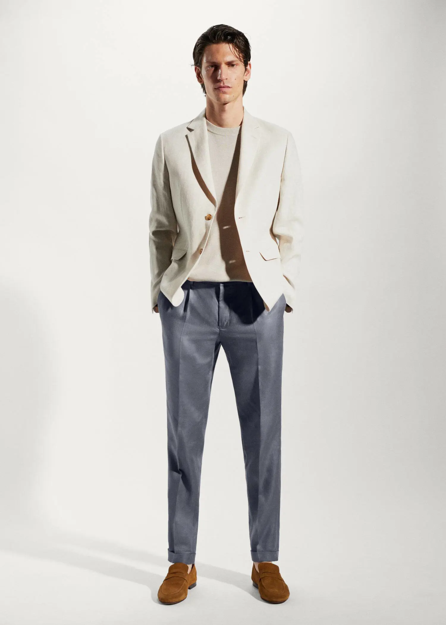 Mango 100% linen regular-fit pants. a man wearing a white jacket and a brown sweater. 