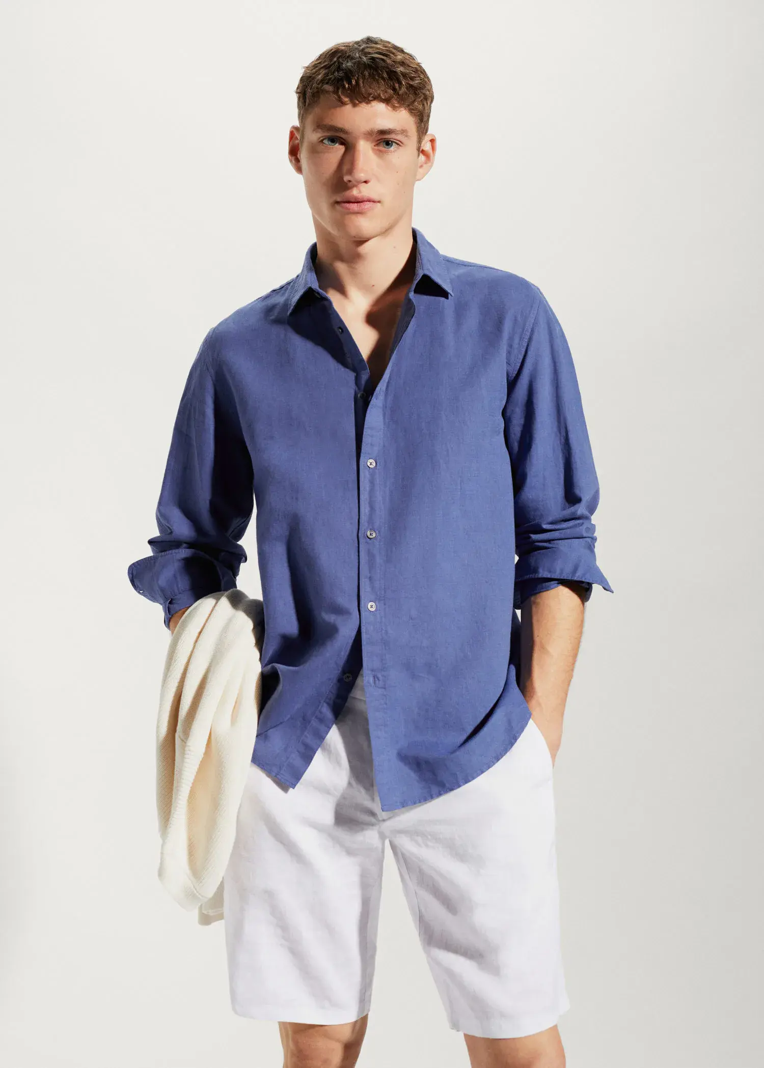Mango Regular-fit linen cotton shirt. a man in a blue shirt and white pants. 
