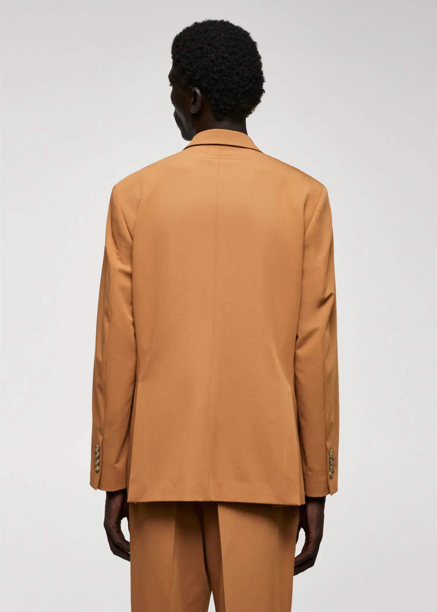 Mango Regular fit suit blazer. a person wearing a tan suit jacket. 
