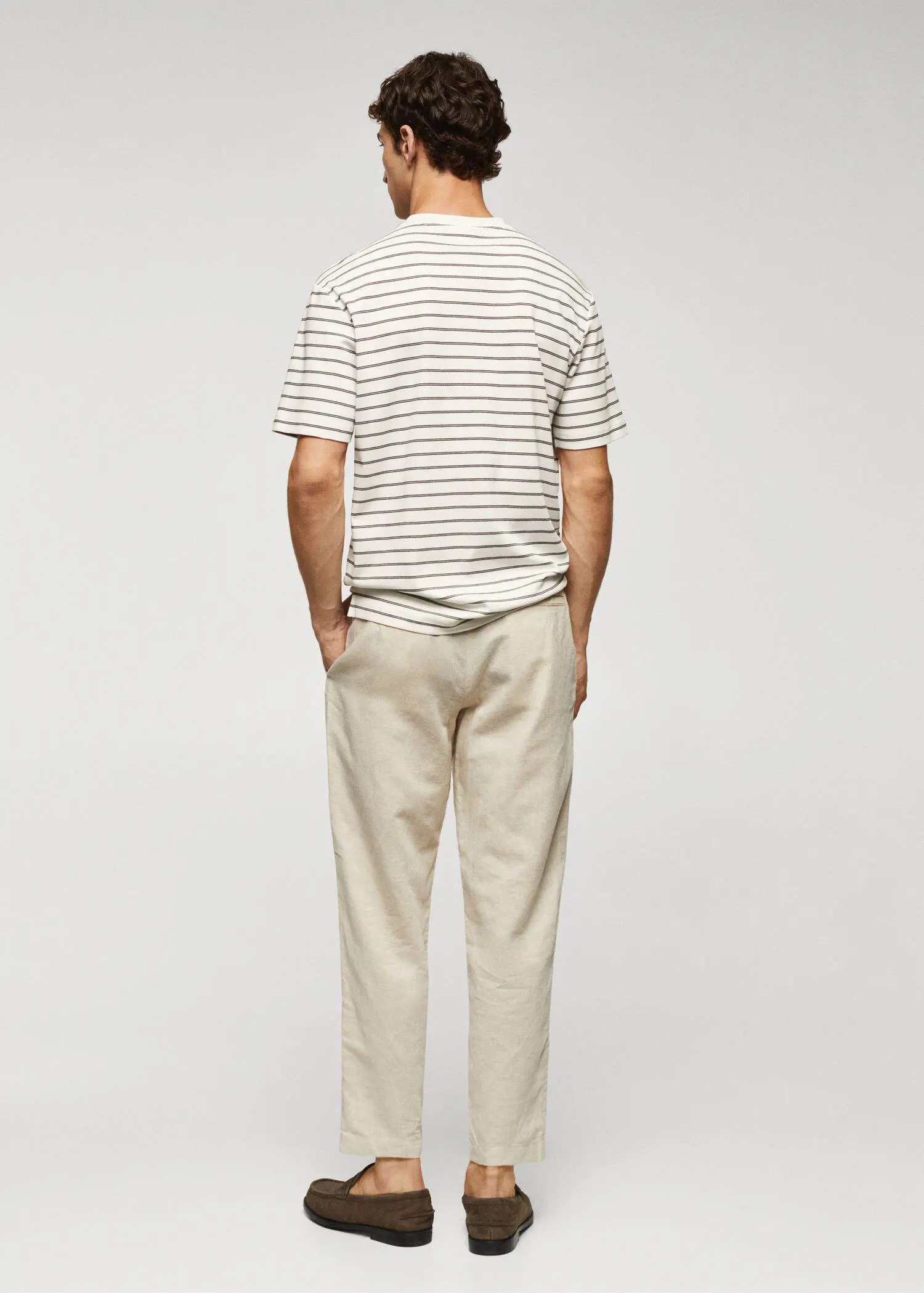 Mango Striped 100% cotton t-shirt. a man wearing a striped shirt and beige pants. 