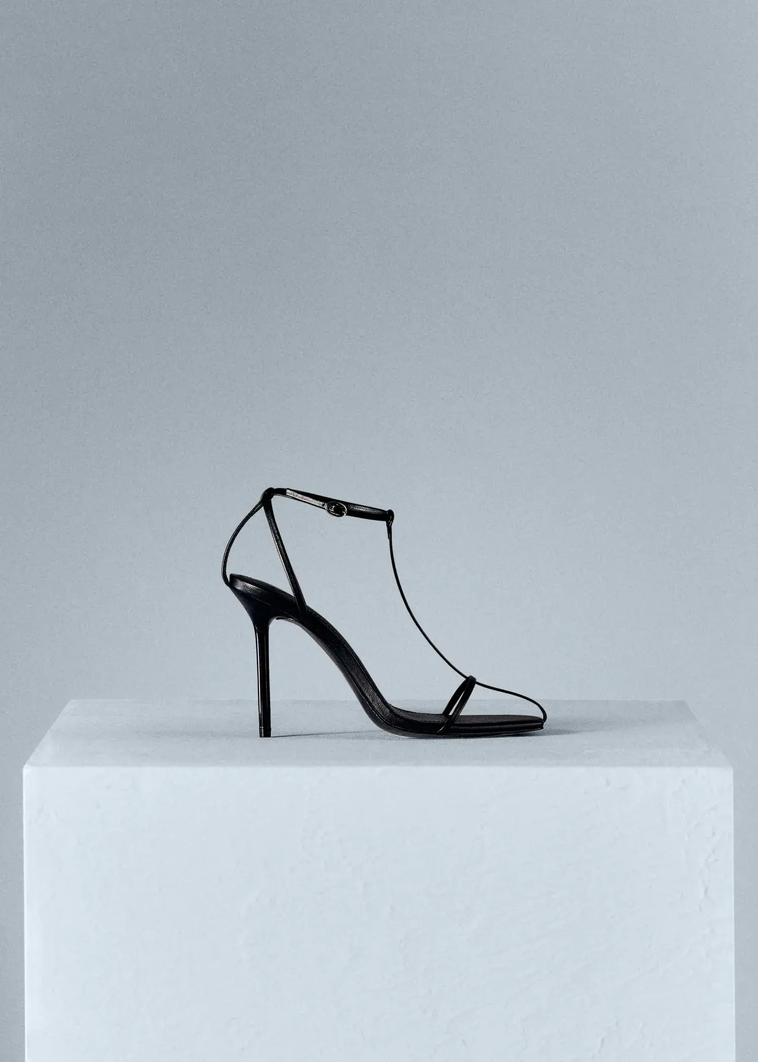 Mango Straps heel leather sandals. a pair of black high heels sitting on top of a box. 