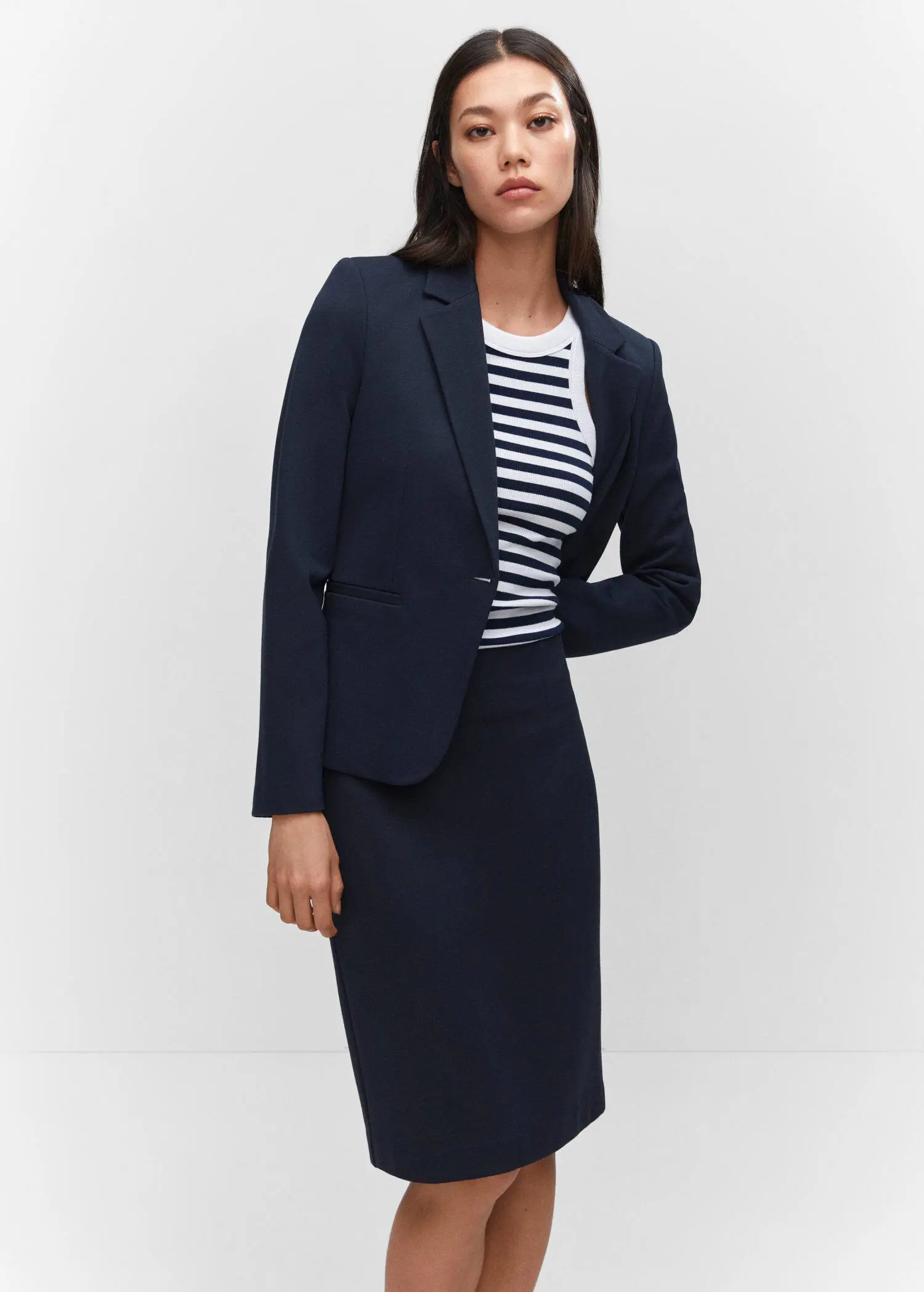 Mango Fitted jacket with blunt stitching. a woman wearing a black and white striped shirt and a black jacket. 