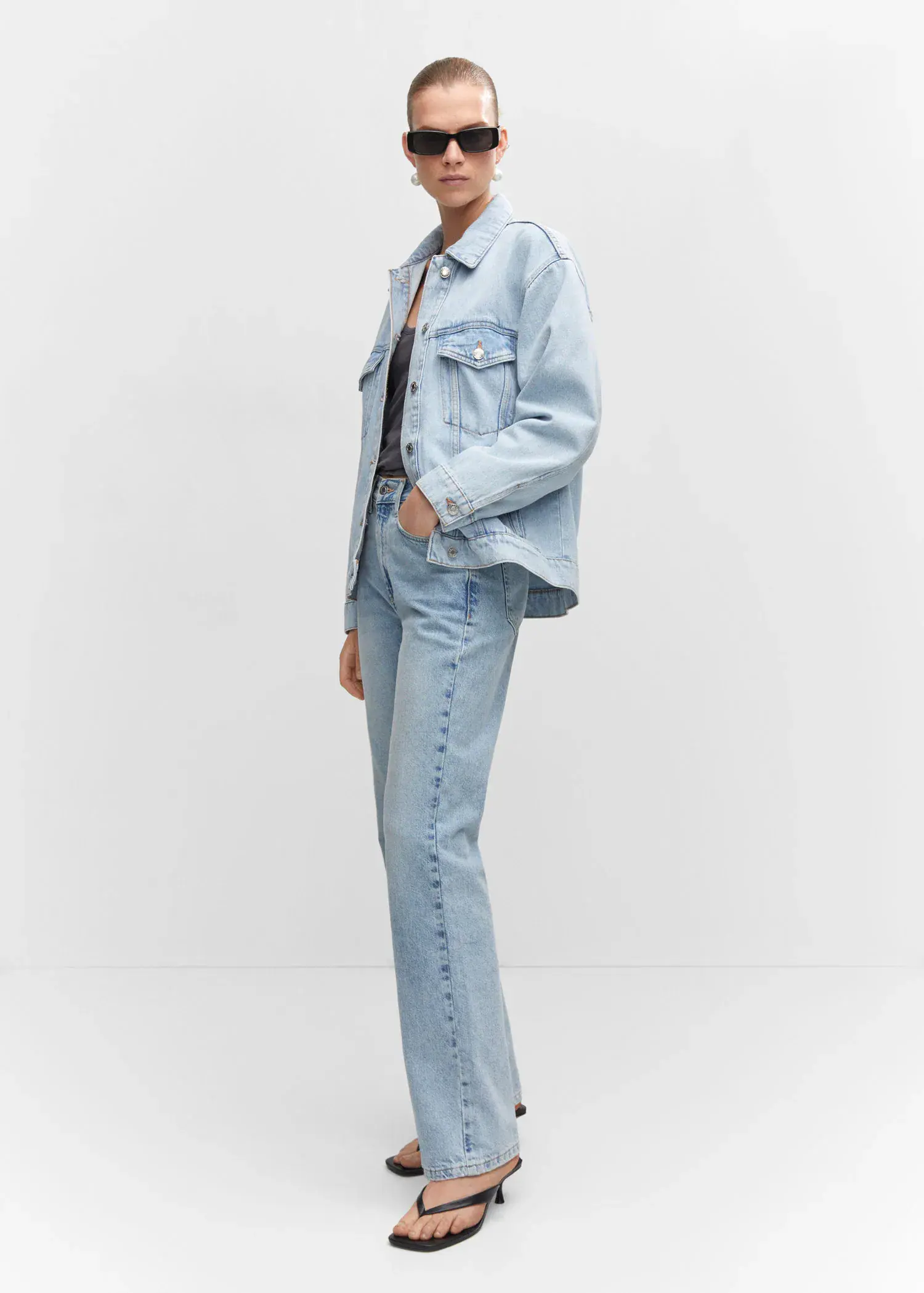 Mango Oversize denim jacket. a person standing in a room wearing a jacket. 