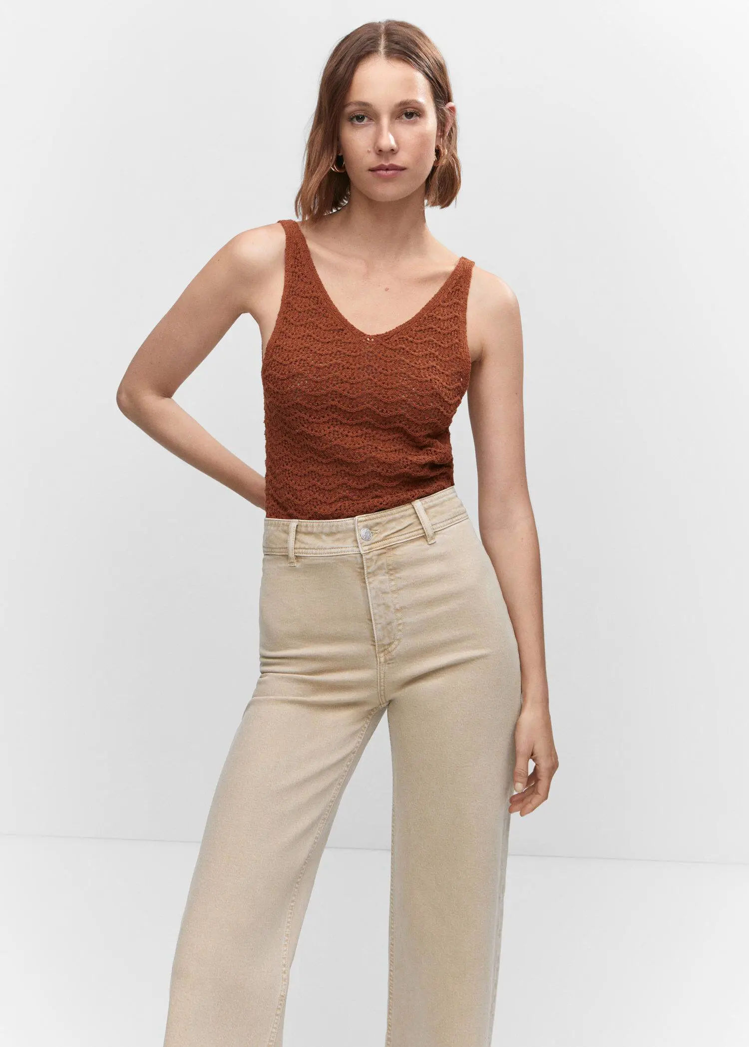 Mango Jeans culotte high waist. a woman in a brown top is posing for a picture. 