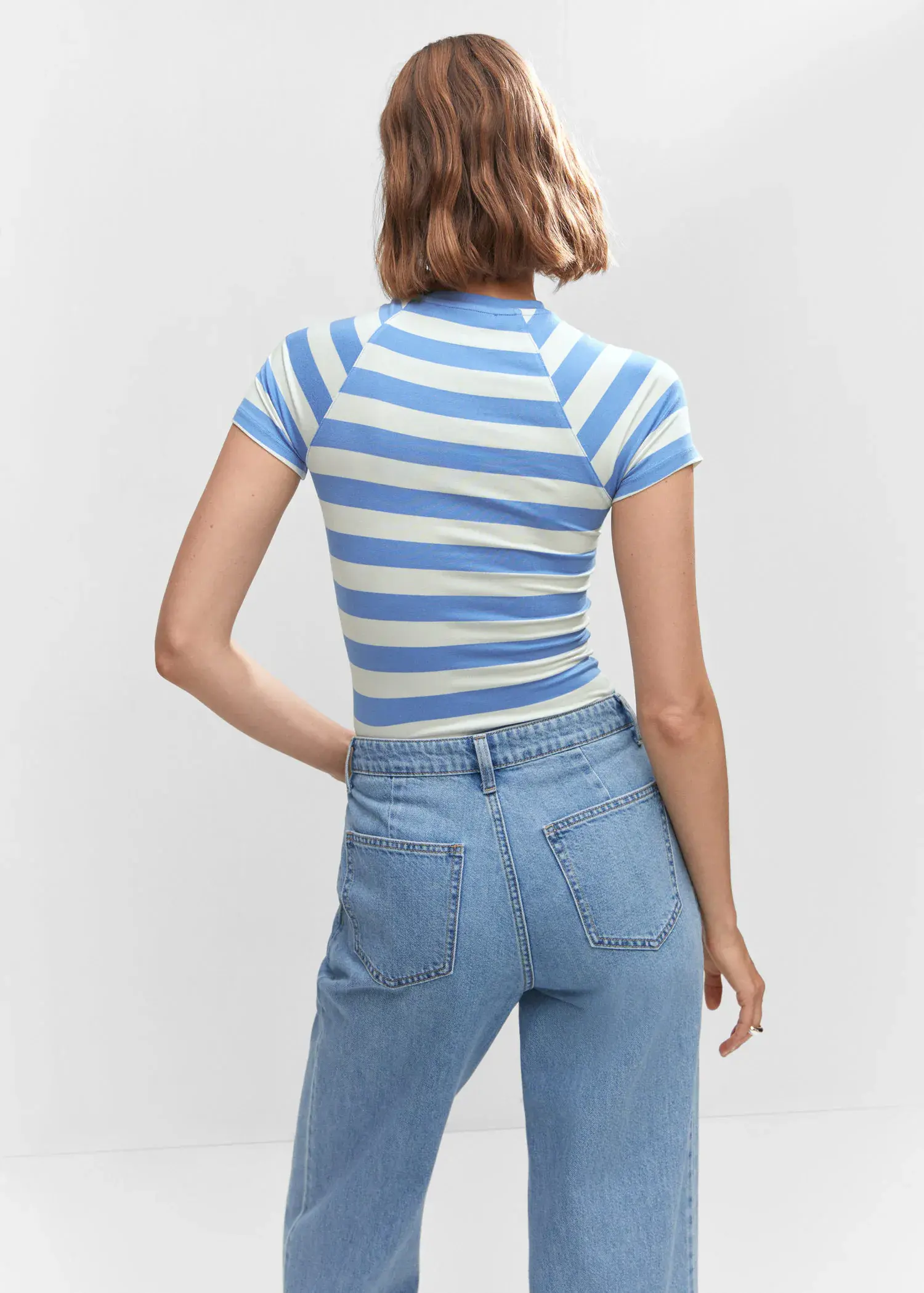 Mango Striped print T-shirt. a woman in a blue and white striped shirt and jeans. 