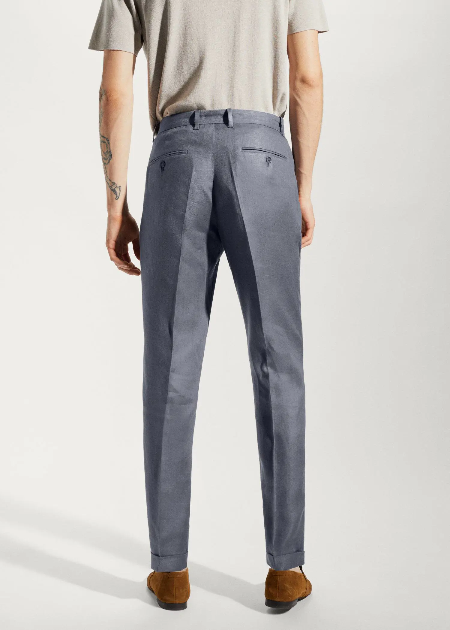 Mango 100% linen regular-fit pants. a man wearing a pair of gray pants. 