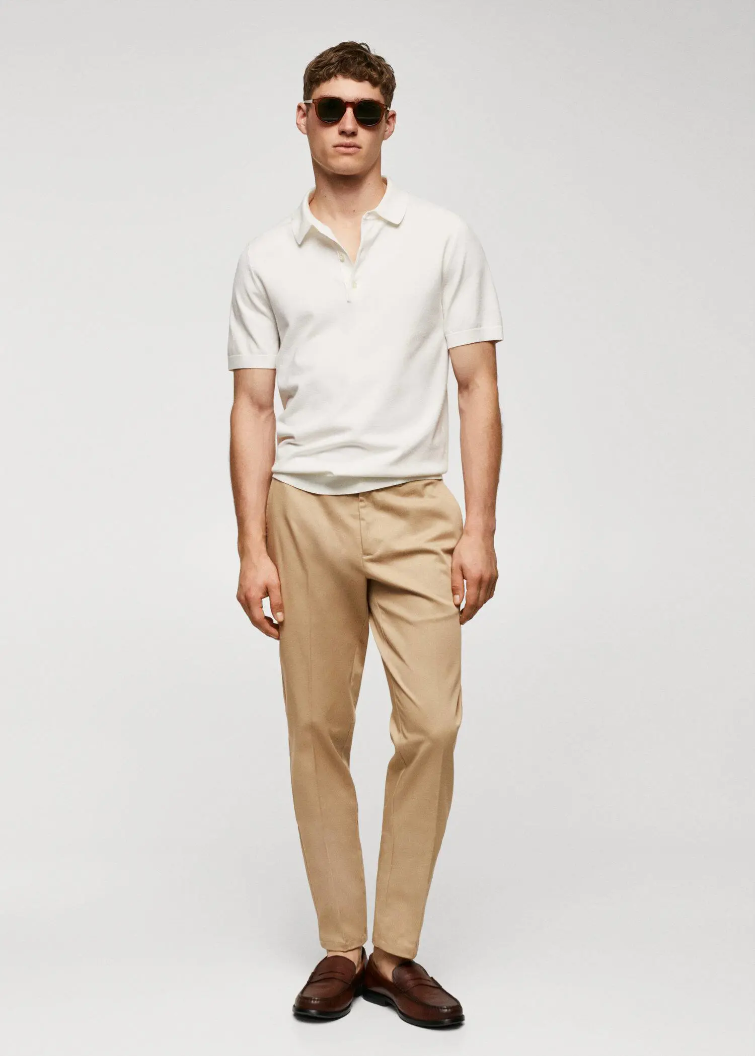 Mango Slim fit chino trousers. a man in a white shirt and tan pants. 