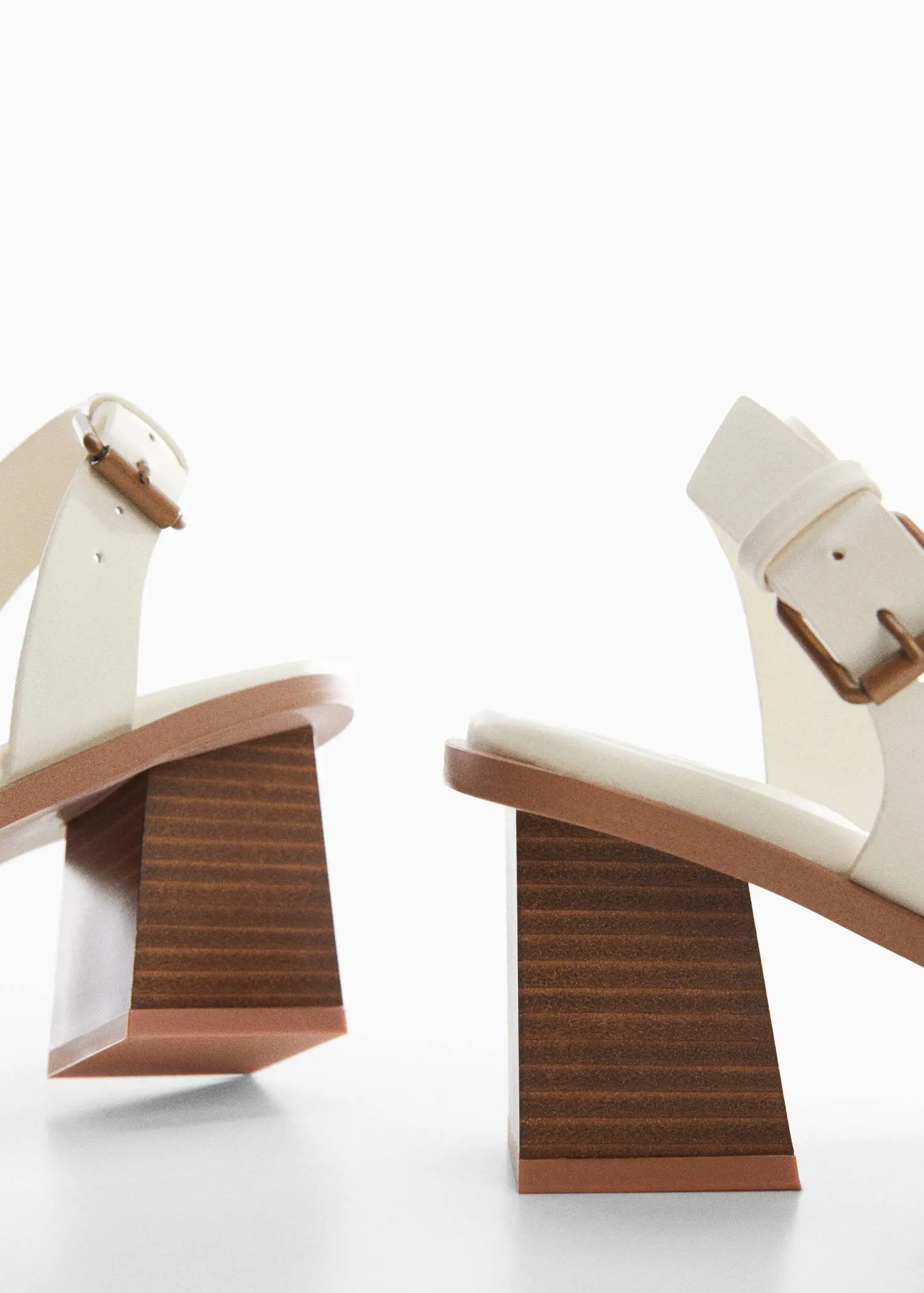 Mango Block-heel sandals. a pair of white sandals sitting on top of a wooden platform. 