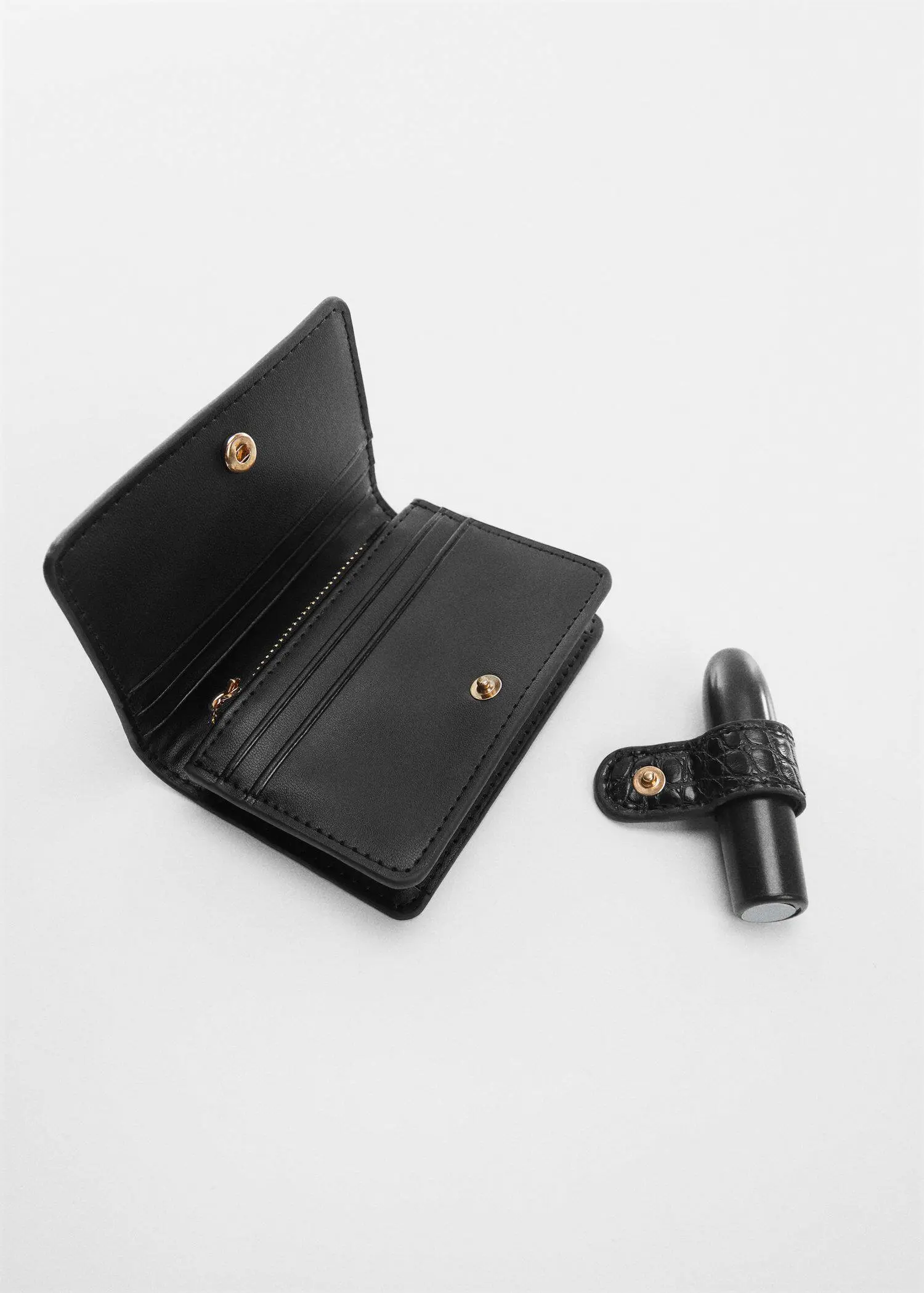 Mango Animal print effect wallet. a black wallet next to an electronic cigarette. 