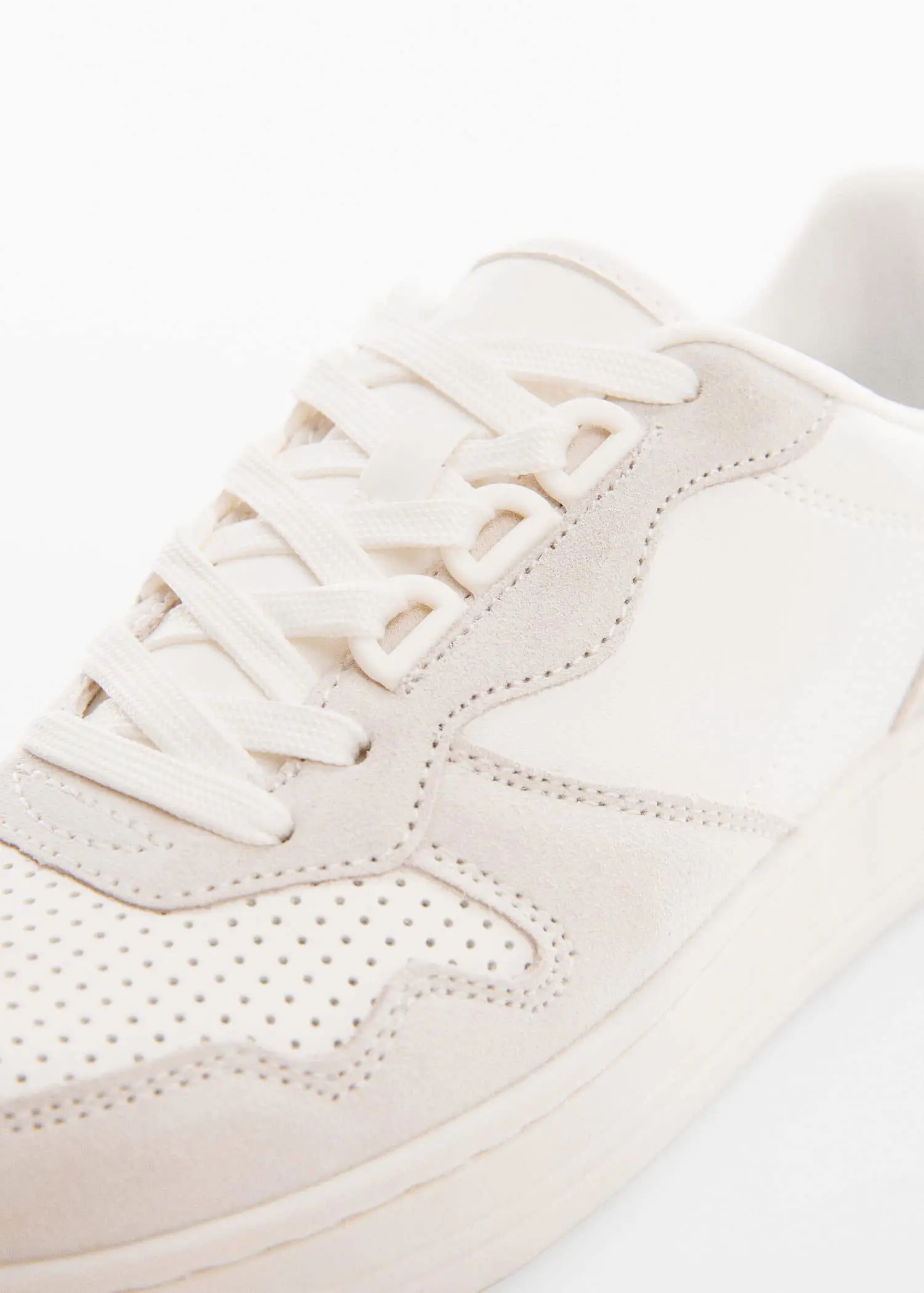Mango Panels leather sneakers. a close-up view of a pair of white sneakers. 
