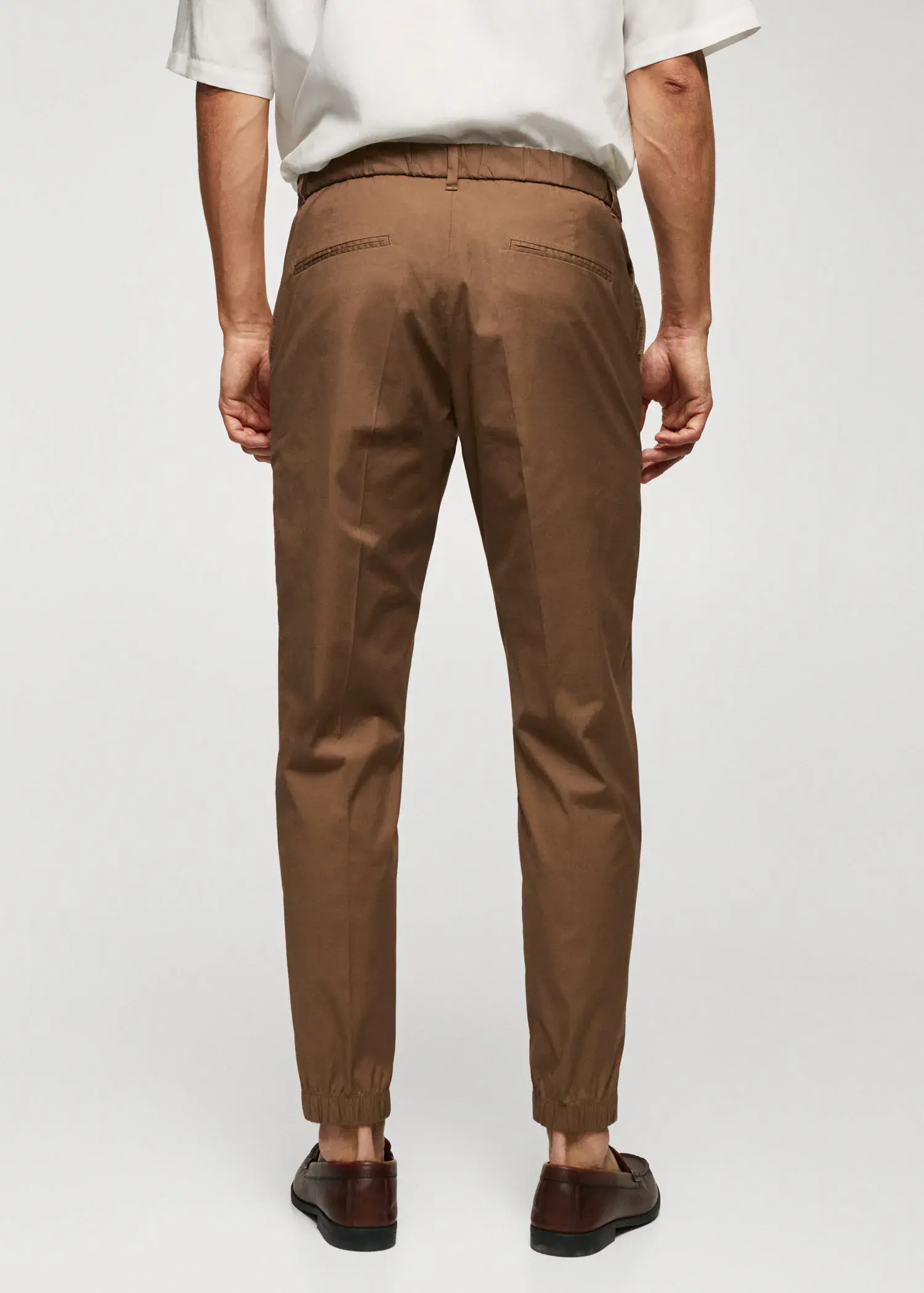 Mango Slim-fit cotton trousers. a man wearing brown pants and a white shirt. 