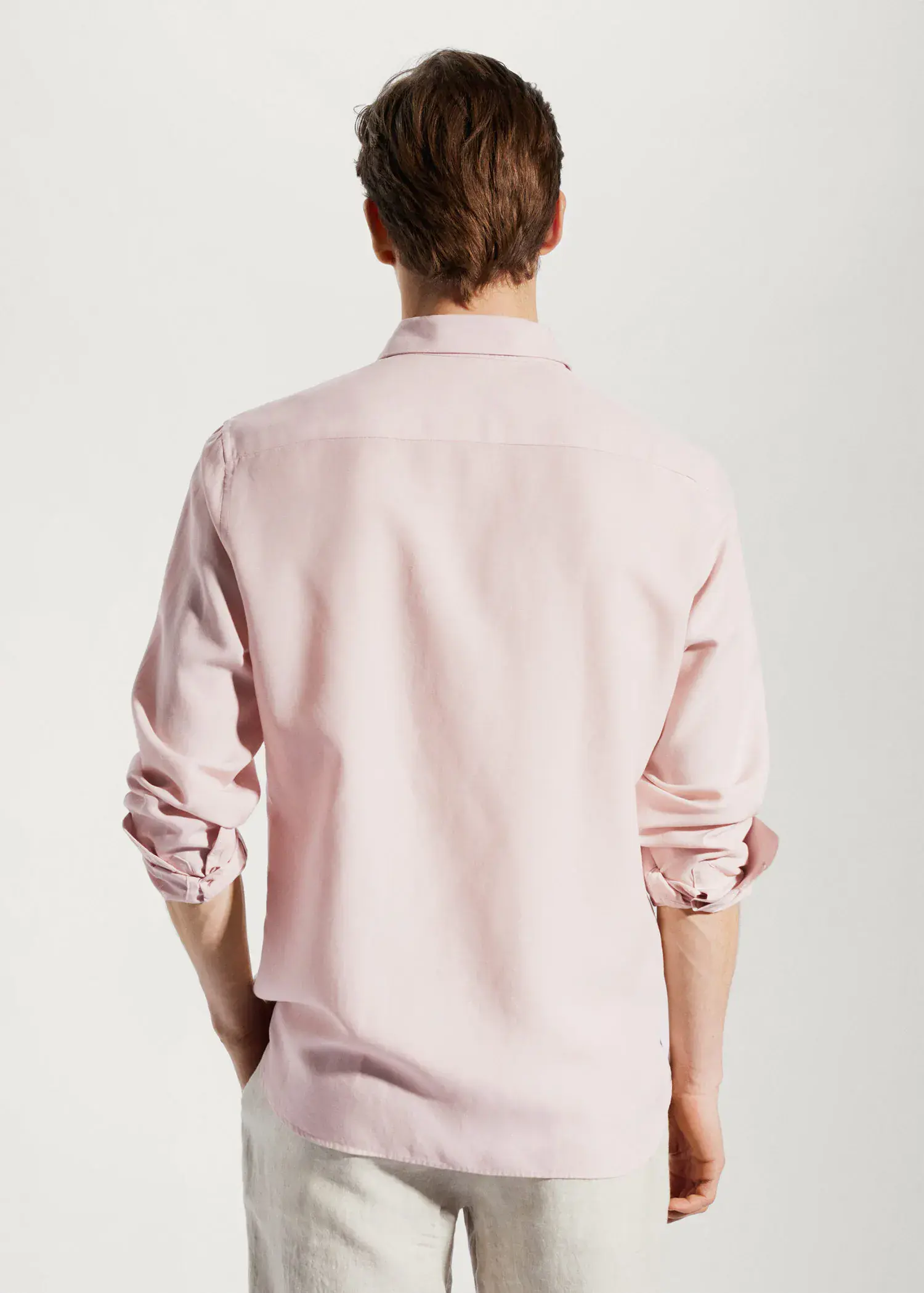 Mango Light tencel-linen shirt. a man wearing a light pink button up shirt. 