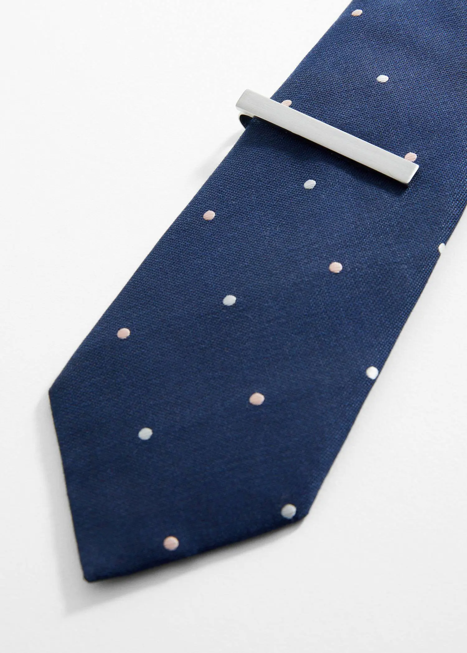 Mango Metal tie clip. a blue tie with white polka dots on it. 