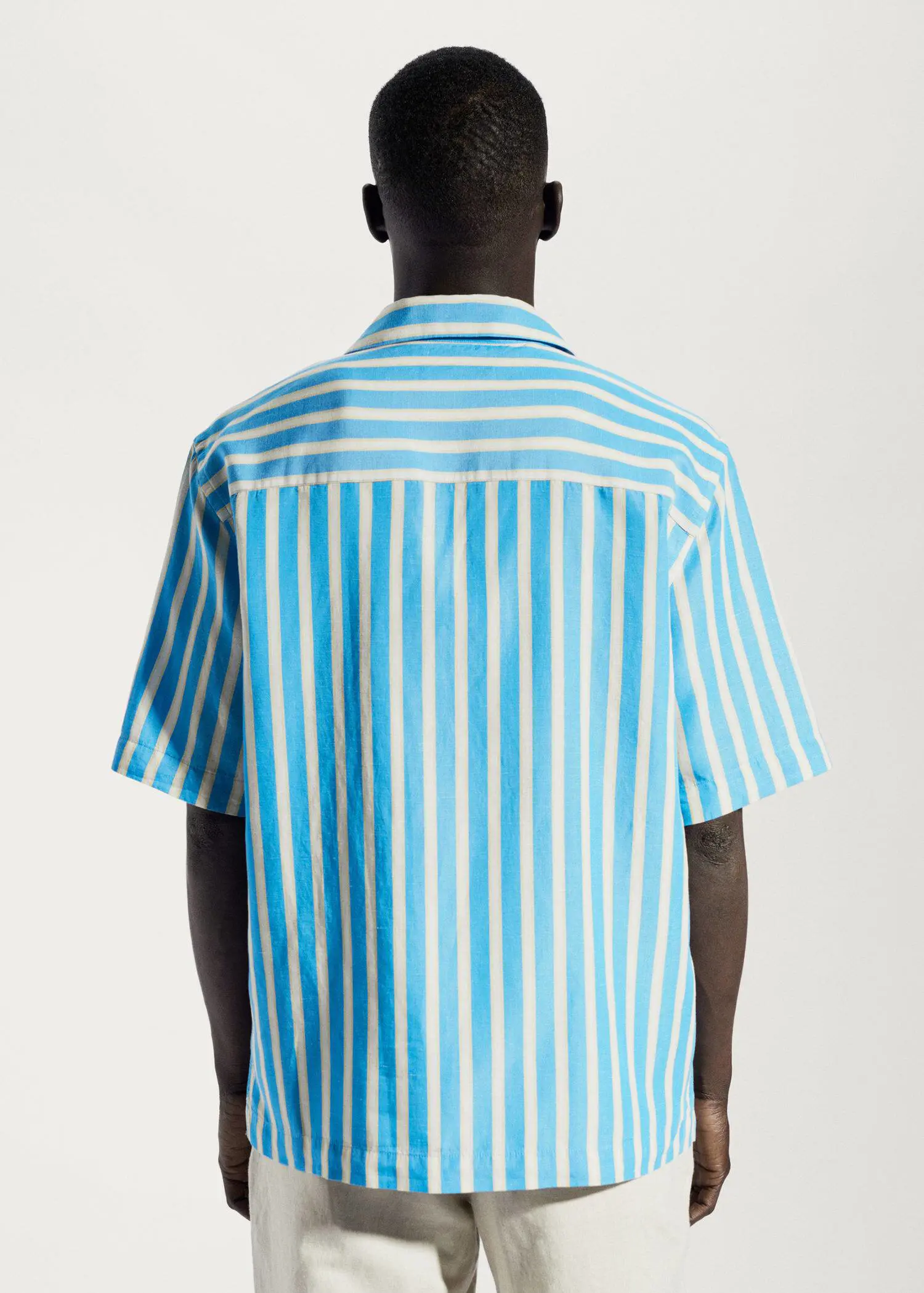 Mango Striped cotton linen shirt. a person wearing a blue and white striped shirt. 