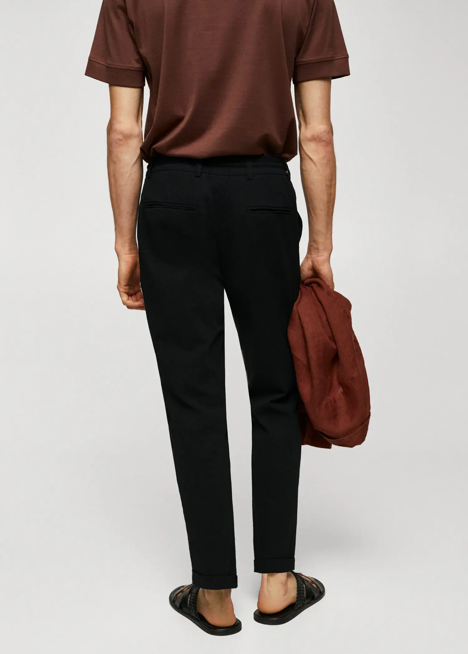 Mango Cotton seersucker trousers with drawstring . a person holding a bag while wearing black pants. 