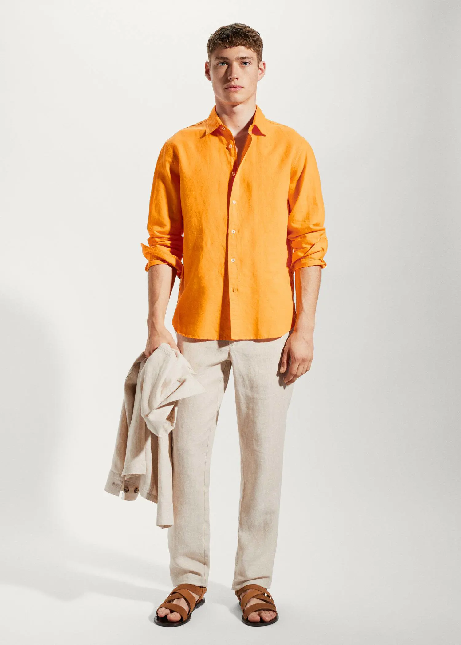 Mango Regular-fit linen cotton shirt. a man in a yellow shirt and white pants. 