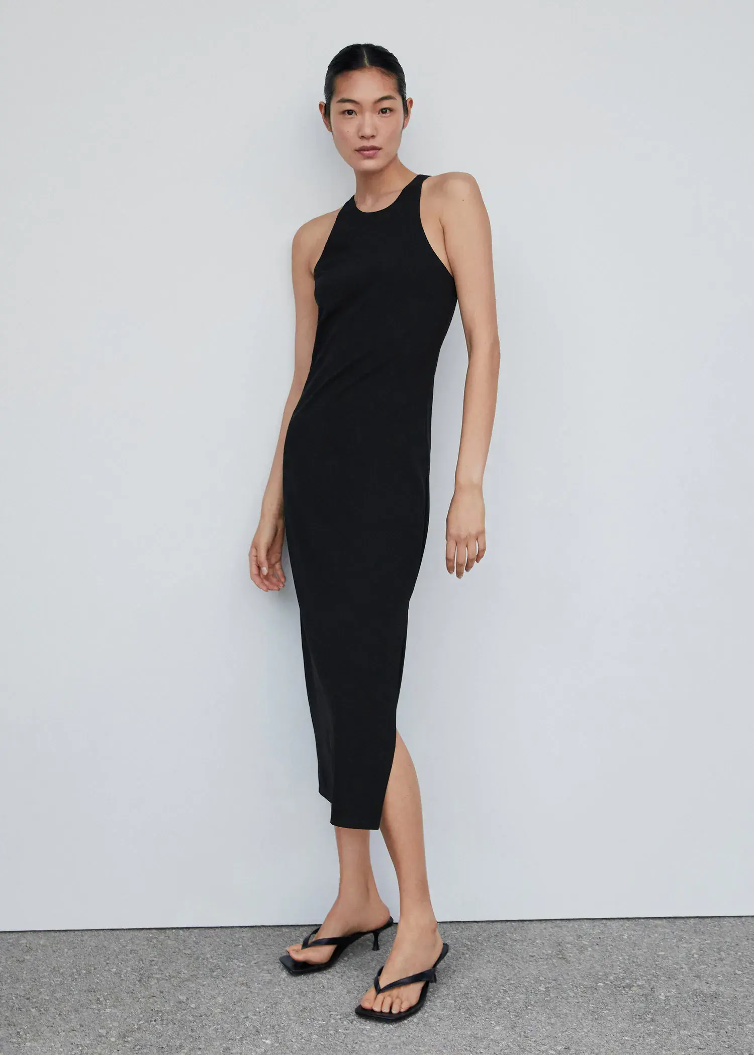 Mango Midi-dress with slit. a woman in a black dress posing for a picture. 
