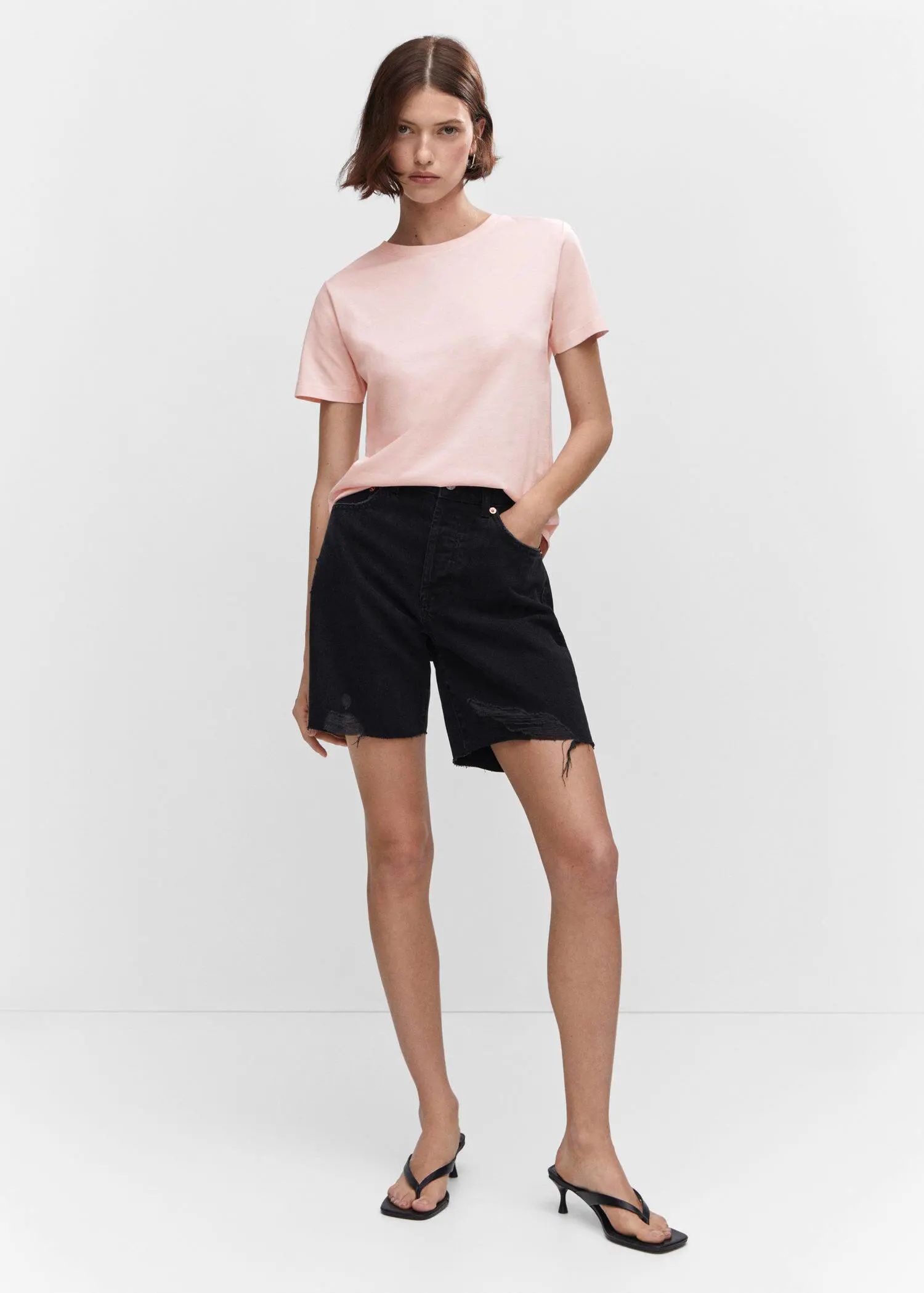 Mango 100% cotton T-shirt. a woman wearing black shorts and a light pink shirt. 