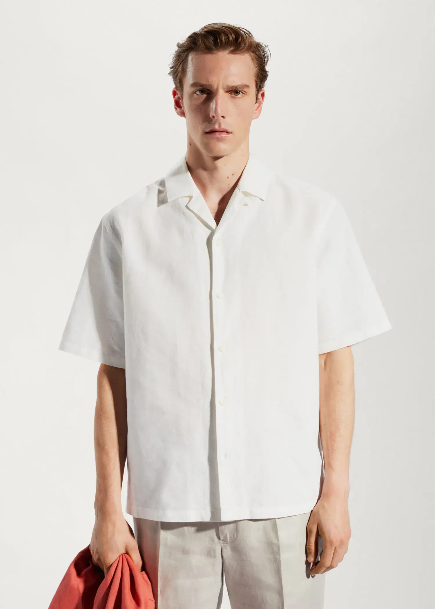 Mango Cotton-linen bowling-collar shirt. a man in a white shirt is posing for a picture. 