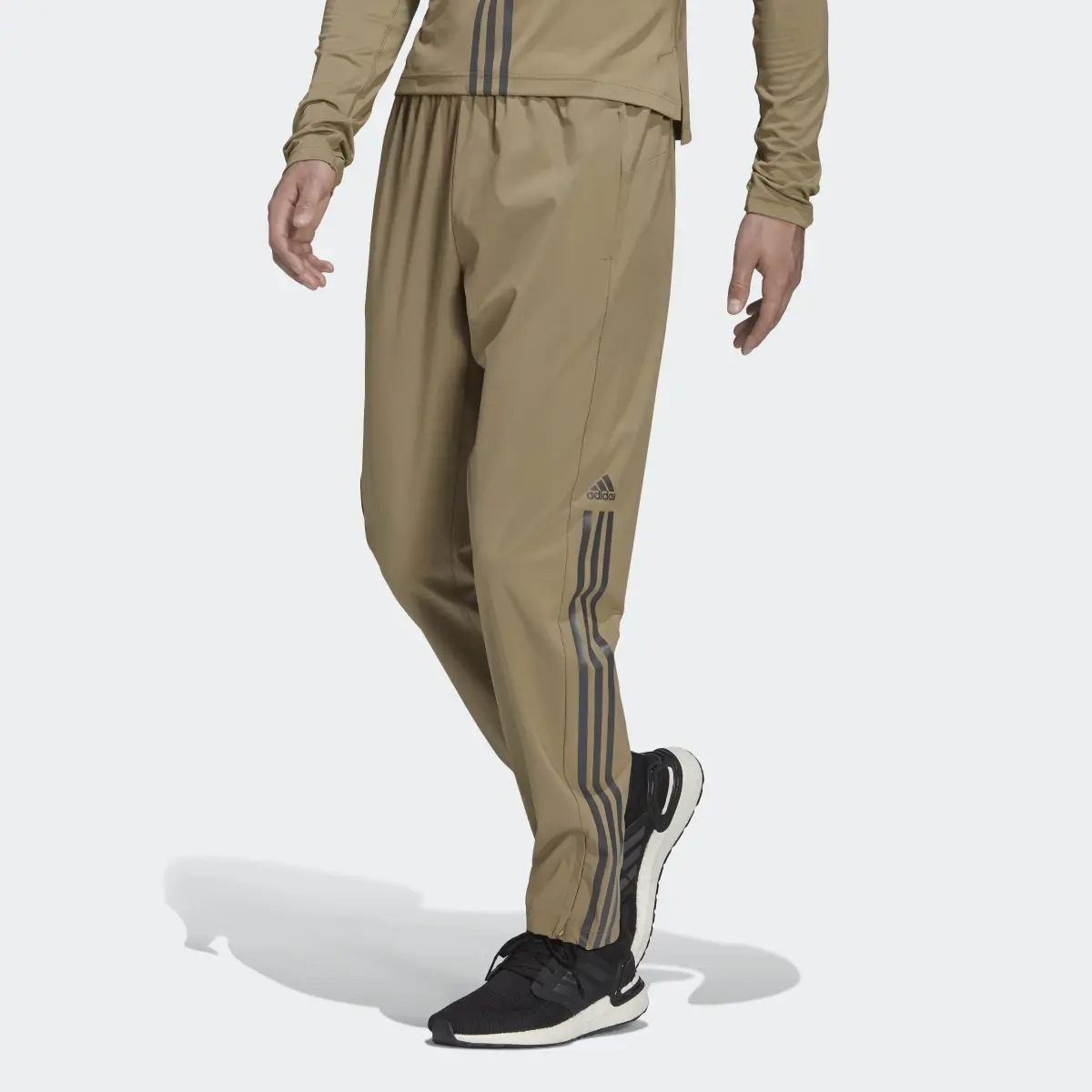 Adidas AlphaStrength Woven Zip Pants. 1