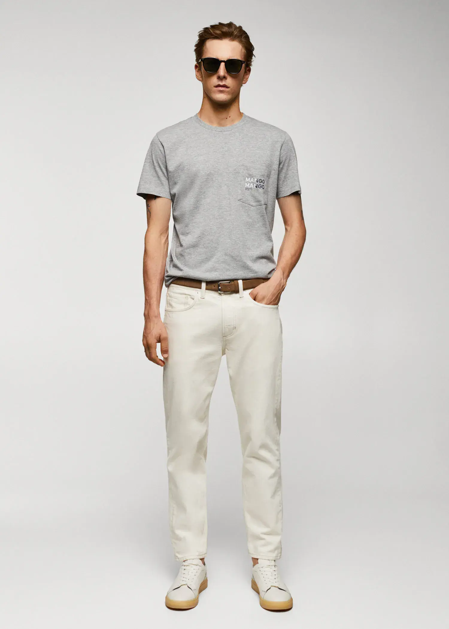 Mango Logo print cotton t-shirt. a man in a gray t-shirt and white pants. 