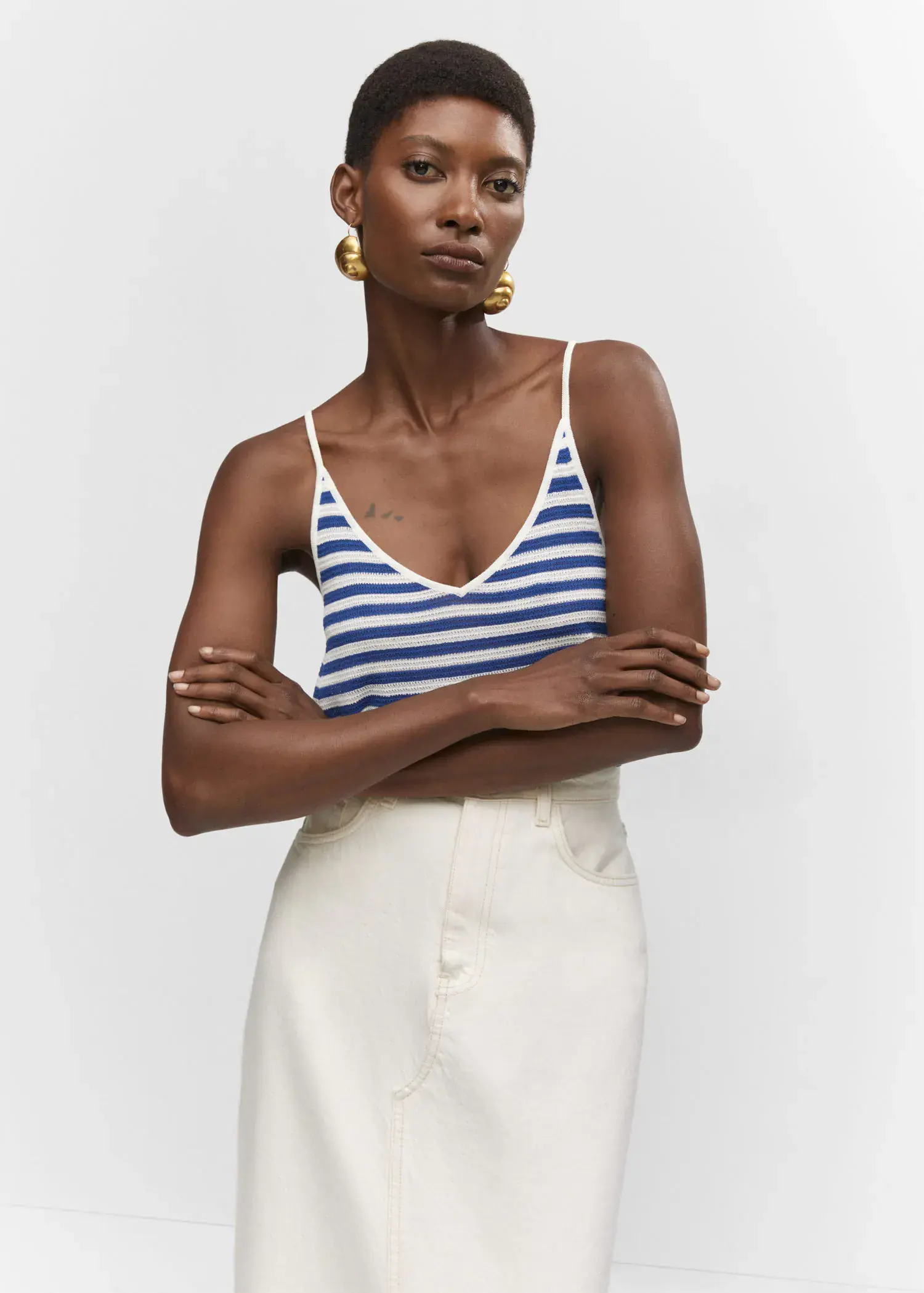 Mango Striped knit top. a woman with her arms crossed wearing a blue and white striped top. 