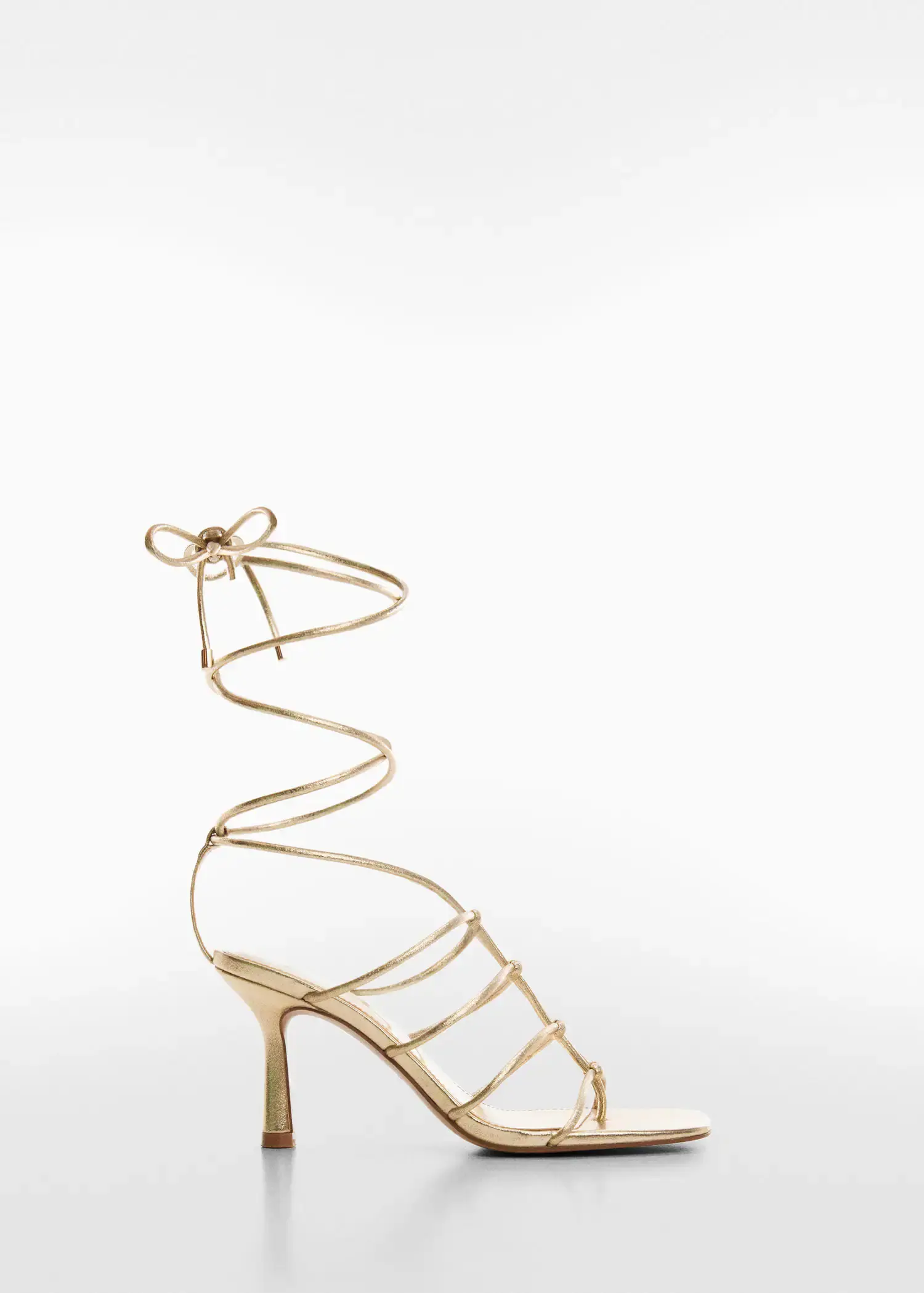 Mango Metallic strappy heeled sandal. a gold strappy high heeled sandal with a bow. 