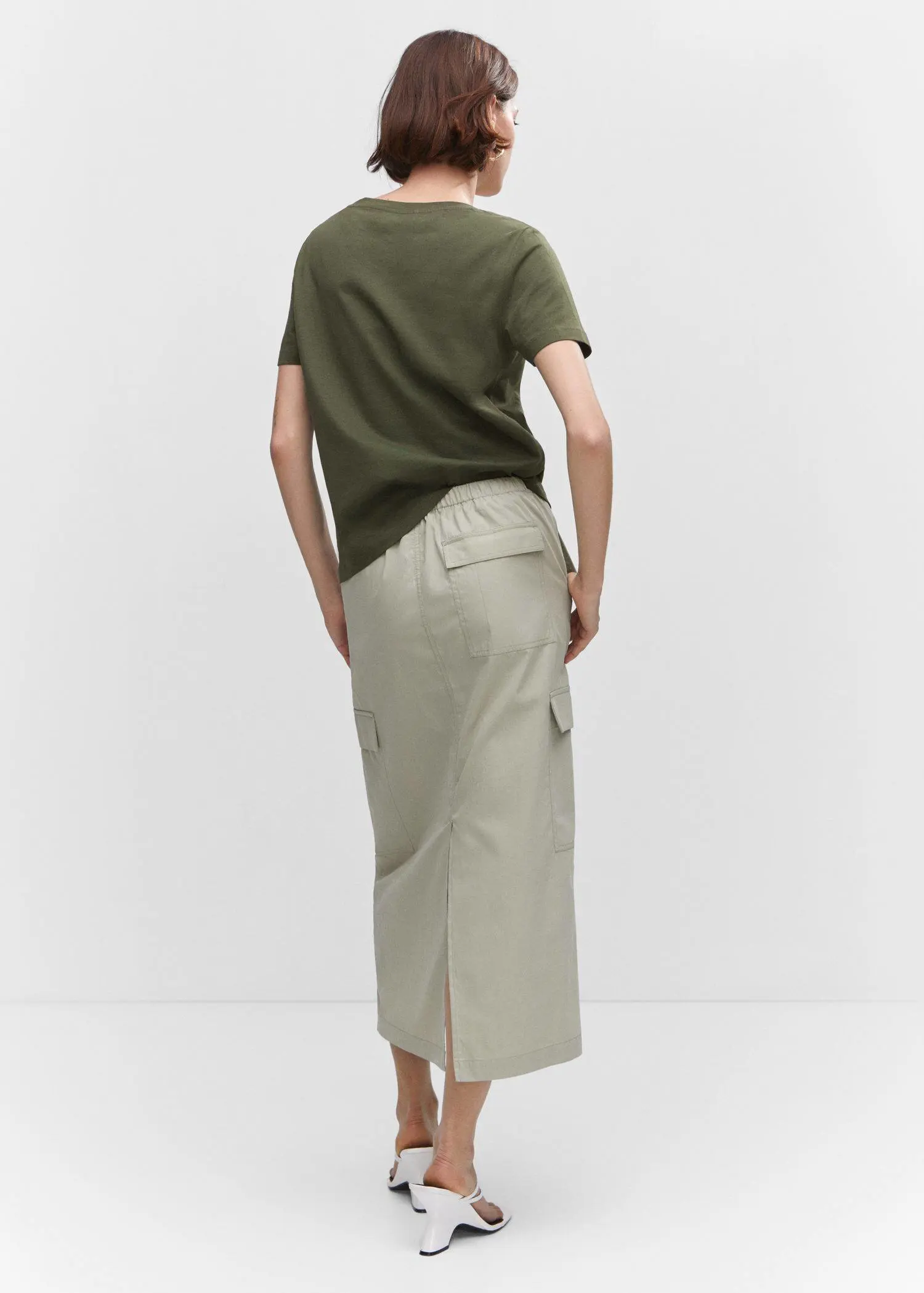 Mango V-neck cotton T-shirt. a person wearing a skirt and a t shirt. 