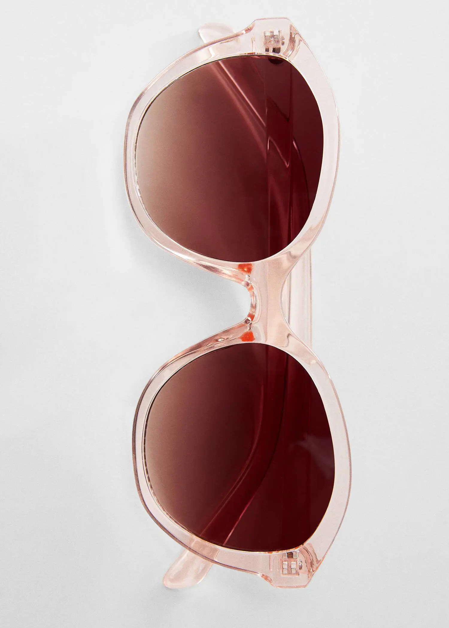 Mango Tortoiseshell rounded sunglasses. a pair of sunglasses hanging on a wall. 