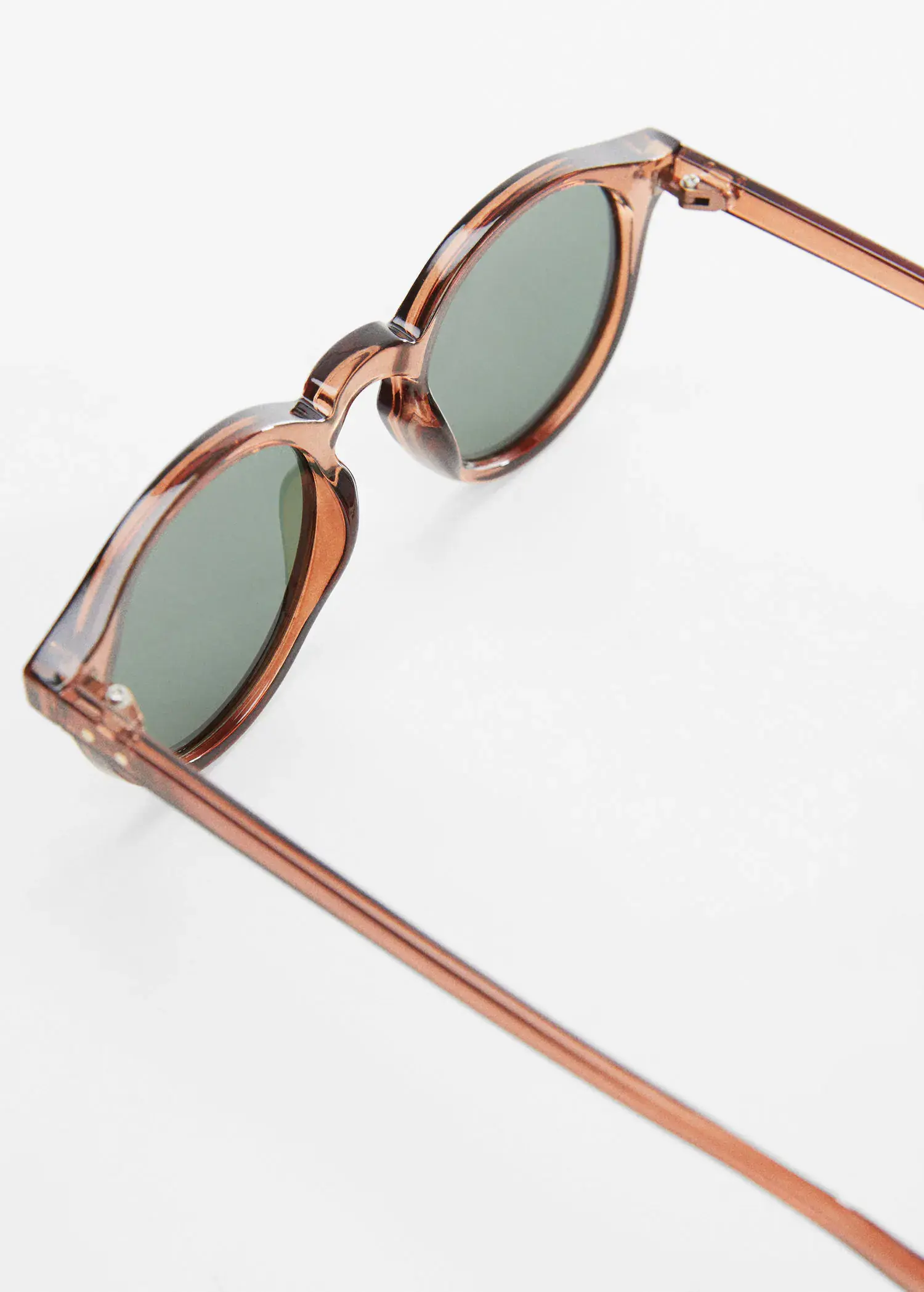 Mango Polarized sunglasses. a close up of a pair of sunglasses on a table 