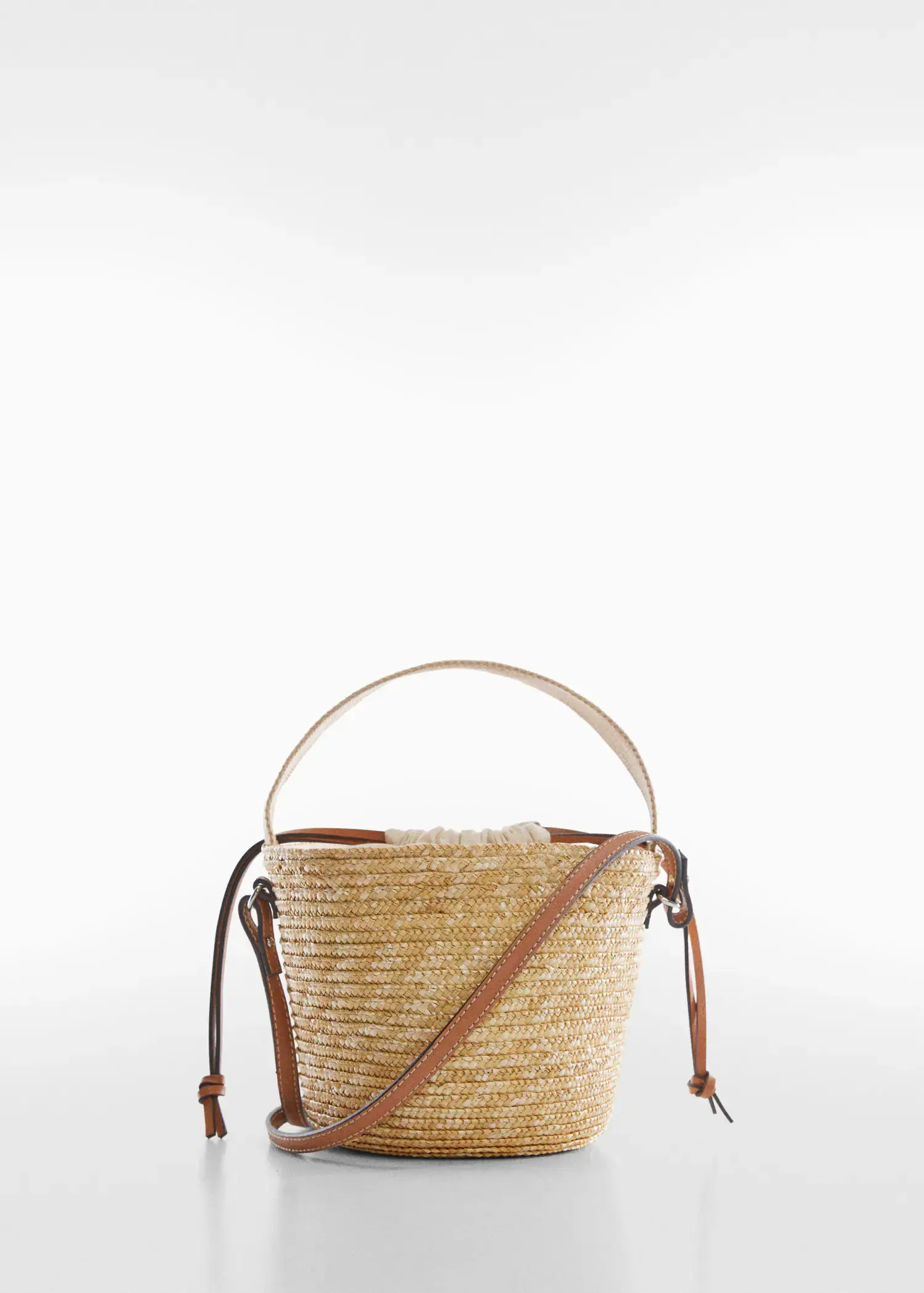 Mango Natural fiber sack bag. a close up of a straw bag on a white background 