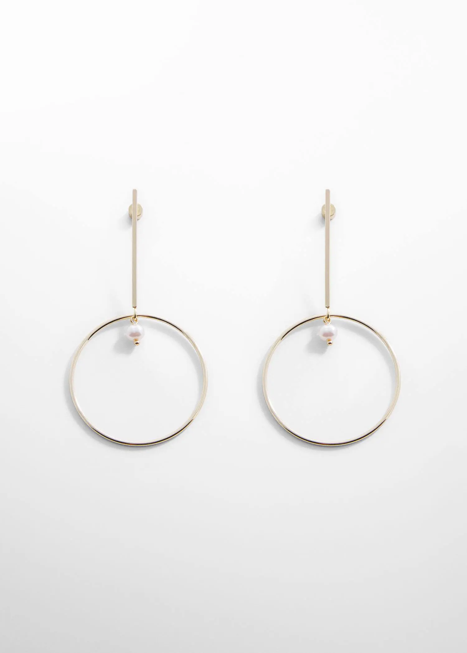 Mango Thread hoop earrings. a pair of earrings hanging on a white wall. 