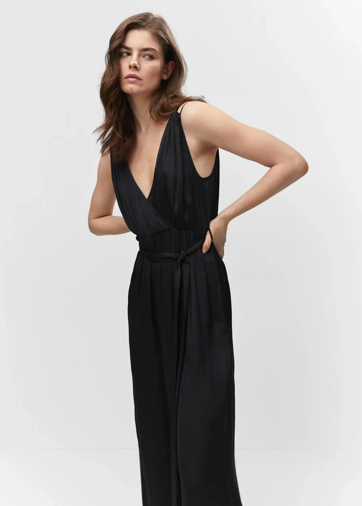 Mango Satin pleated jumpsuit. a woman in a black dress posing for a picture. 