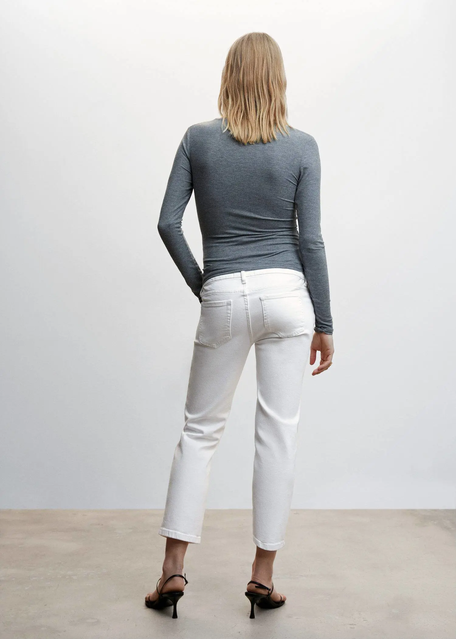 Mango Maternity Straight Jeans. a woman wearing white pants and a gray shirt. 