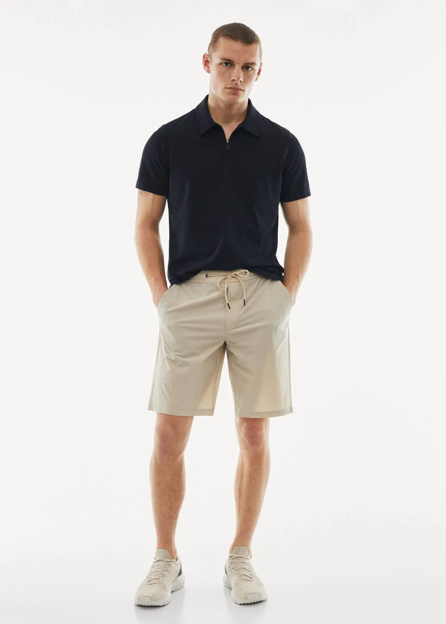 Mango Water-repellent technical bermuda shorts. a man in black shirt and beige shorts. 