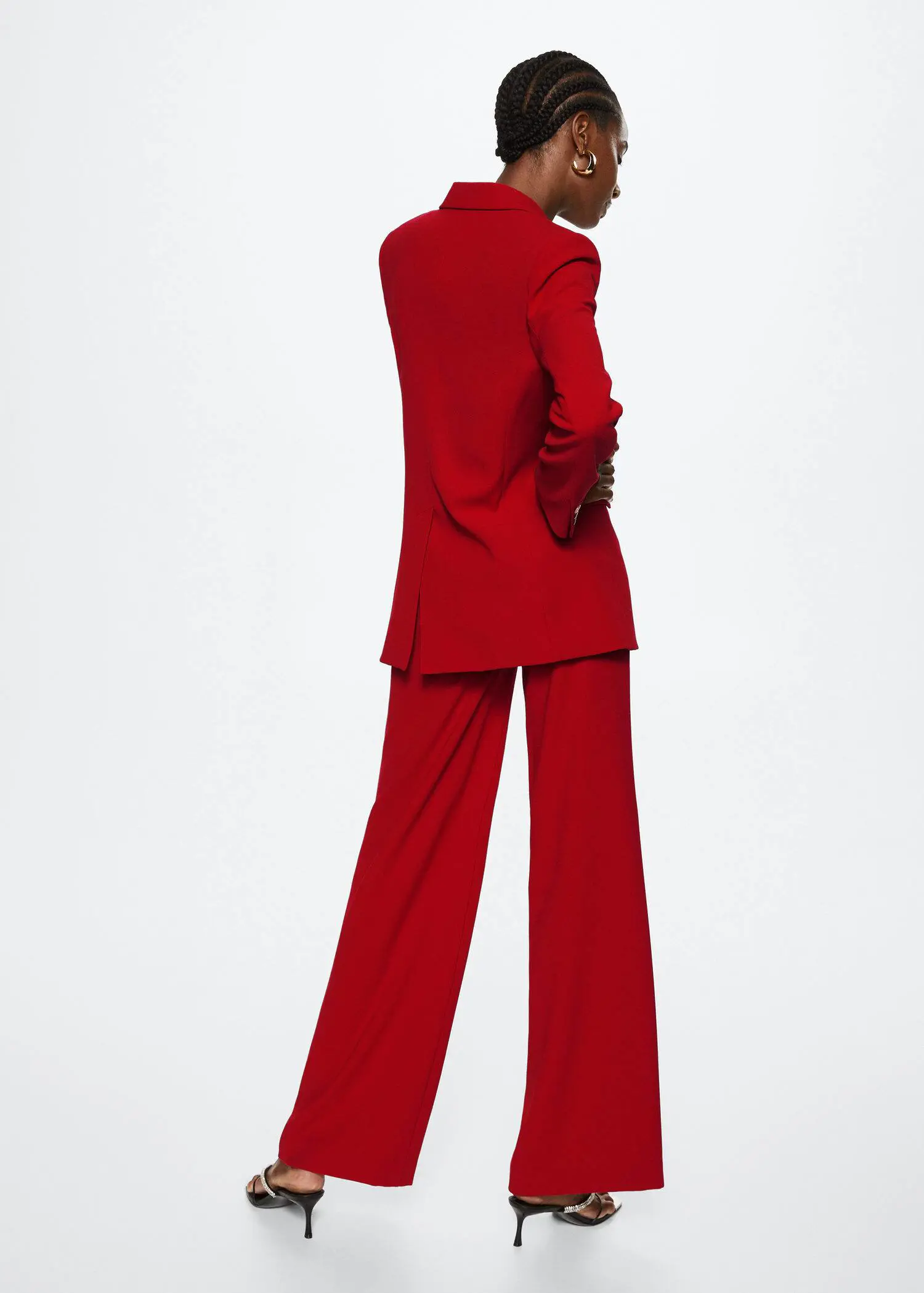 Mango Structured lapels blazer. a woman in a red suit standing in front of a white wall. 