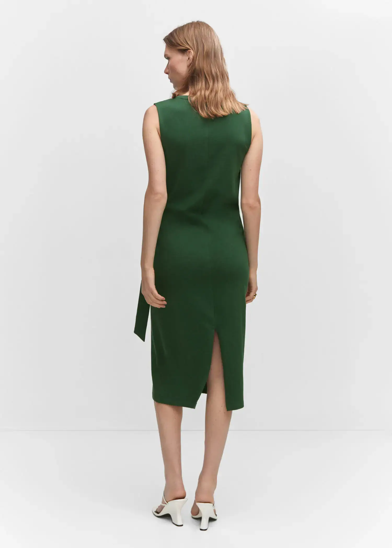 Mango Bow cut-out detail dress. a woman wearing a green dress standing in a room. 