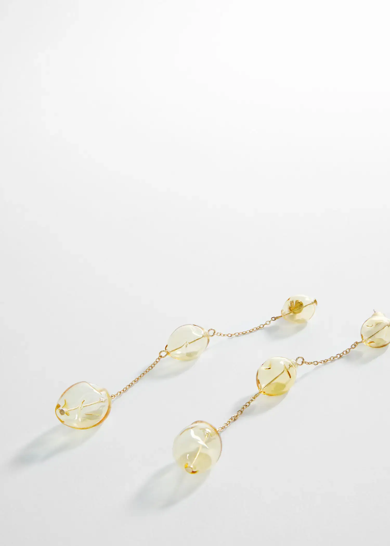 Mango Crystal thread earrings. a close up of a pair of dangling earrings. 
