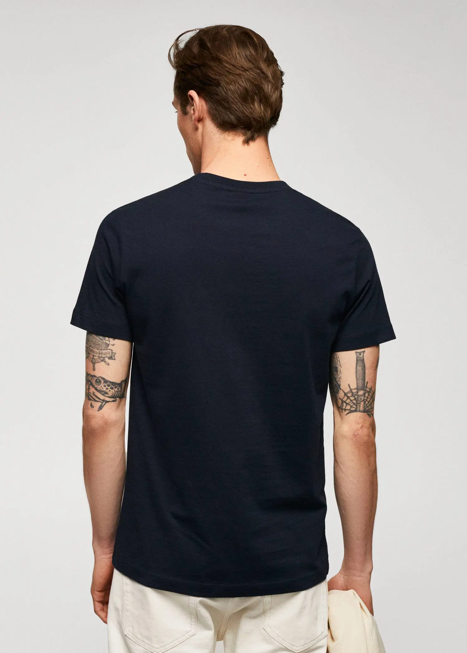 Mango Basic cotton stretch T-shirt. a man wearing a black t-shirt with tattoos. 