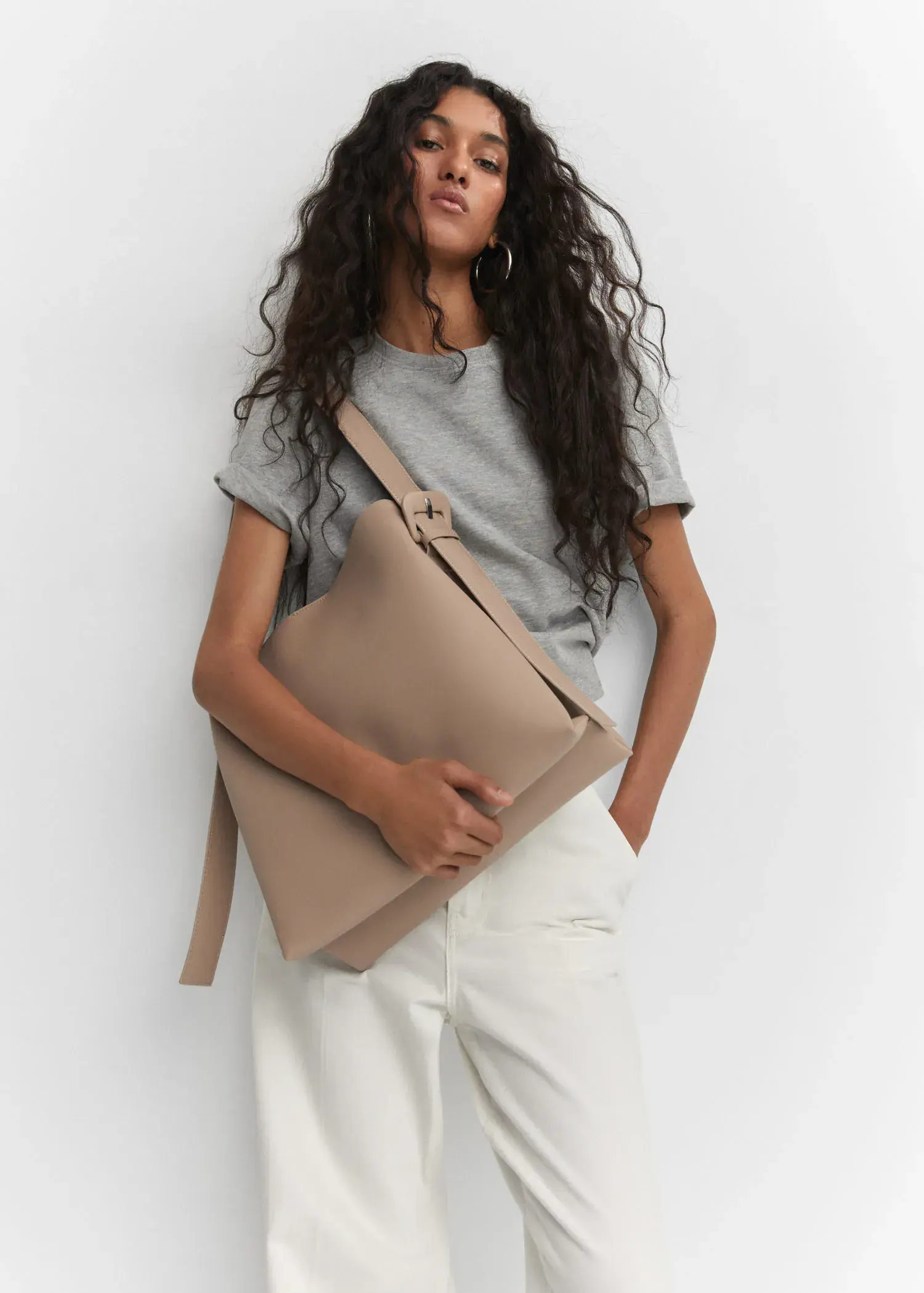 Mango Shopper bag with buckle. a person holding a bag in their hands. 