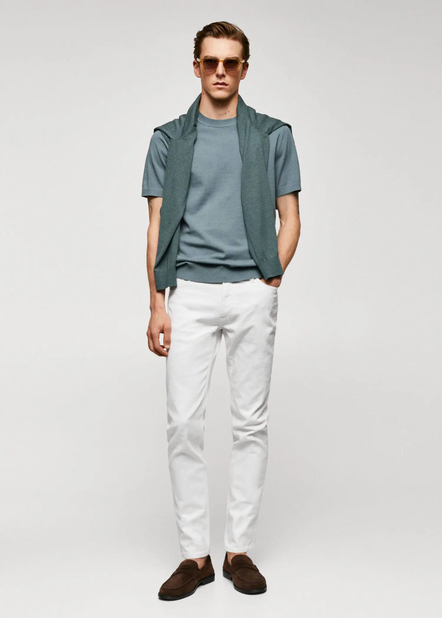 Mango Jan slim-fit jeans. a young man wearing a green vest and white pants. 